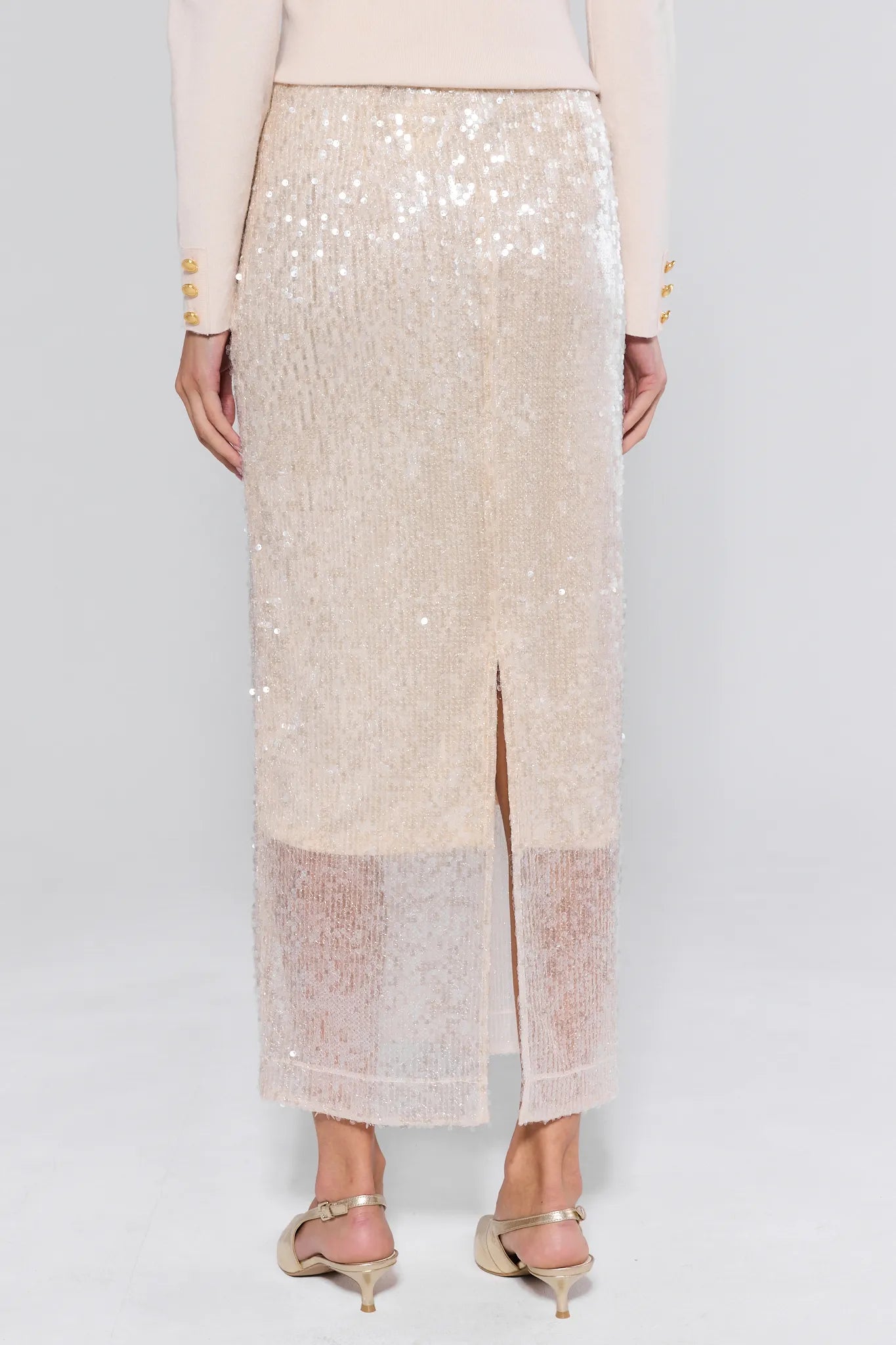 Beige sequin skirt worn by a person on a white background