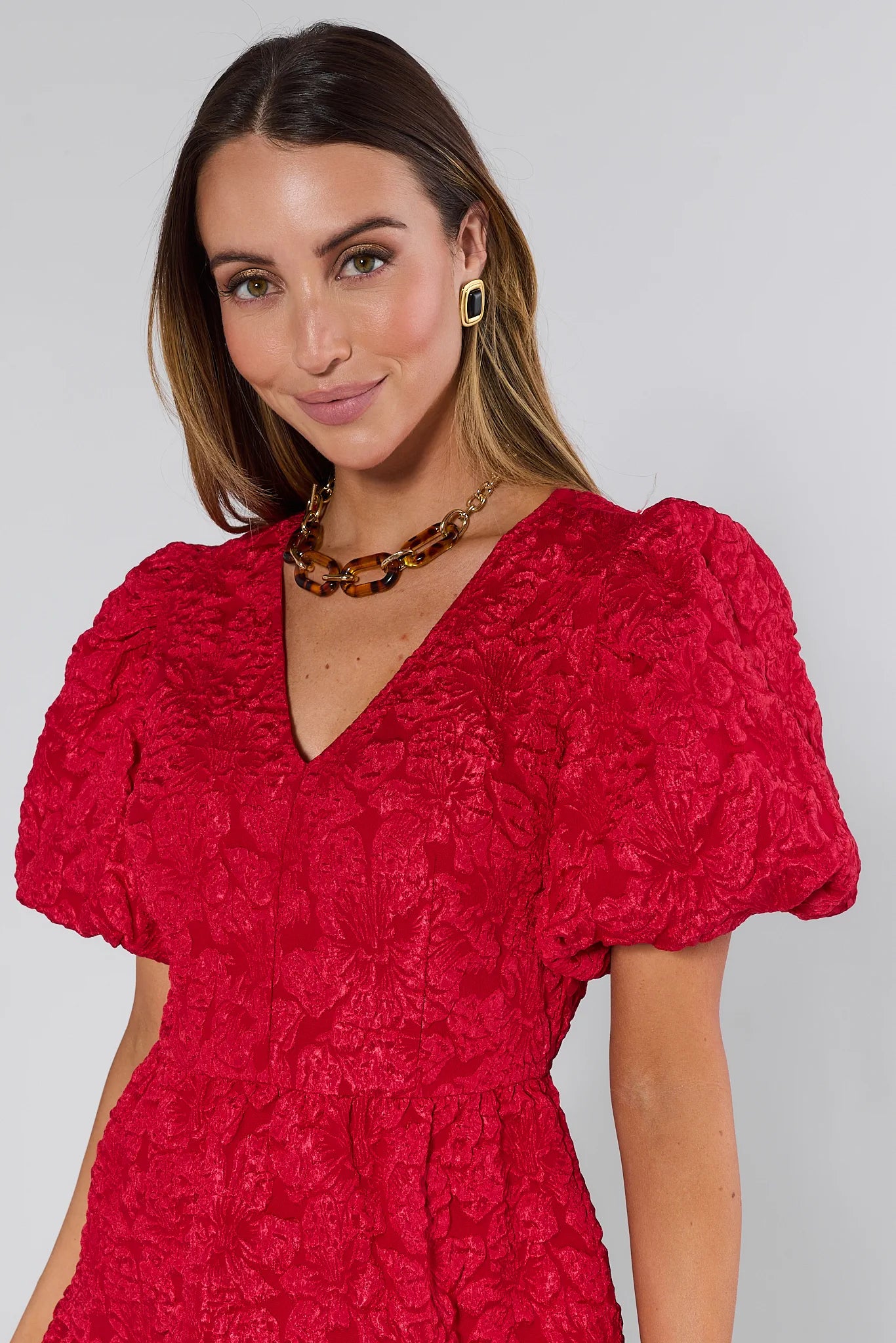 Woman wearing a Teresa Red Floral Short Dress against a white background