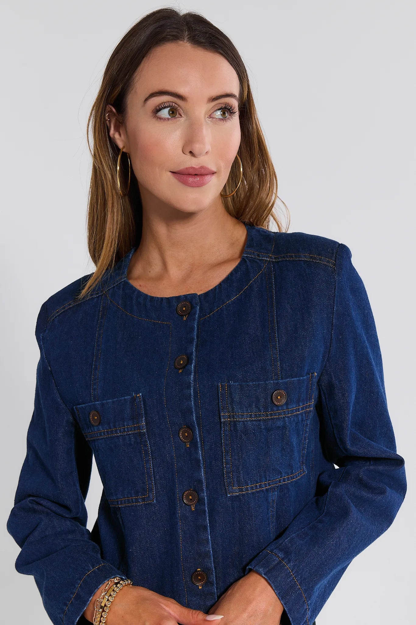 Woman wearing a blue denim Vera Jacket against a white background