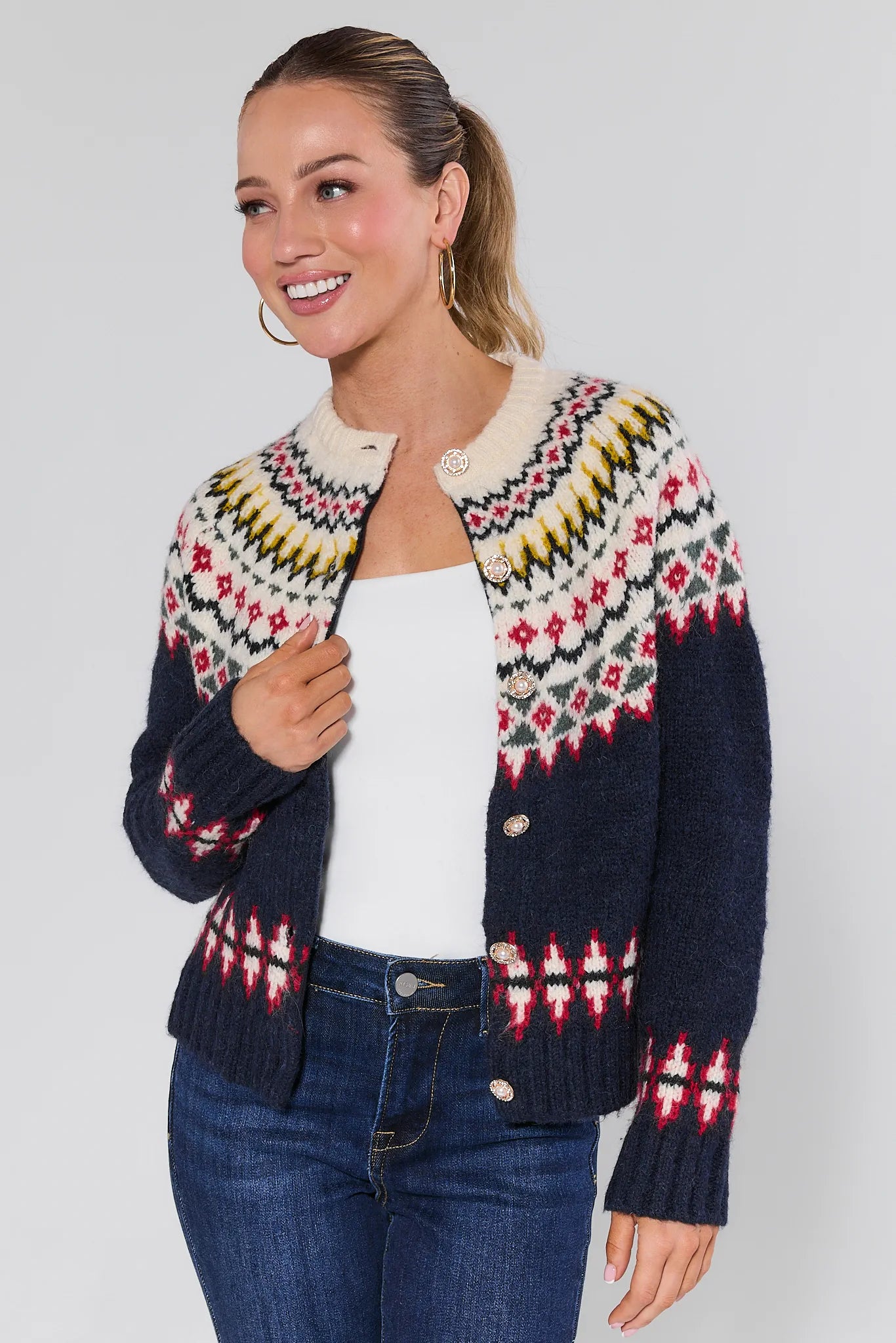 Woman wearing a Aspen Fair Isle Knit Cardigan with a plain background