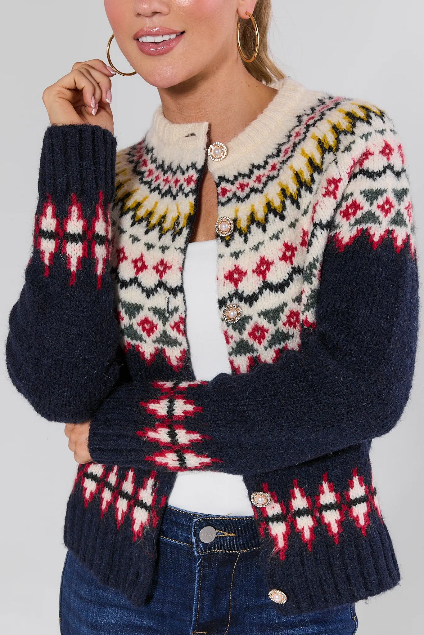 Woman wearing a Aspen Fair Isle Knit Cardigan with a plain background