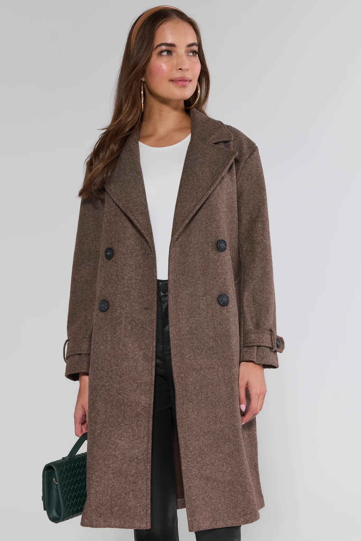 Woman wearing a brown Sadie Coat on a white background