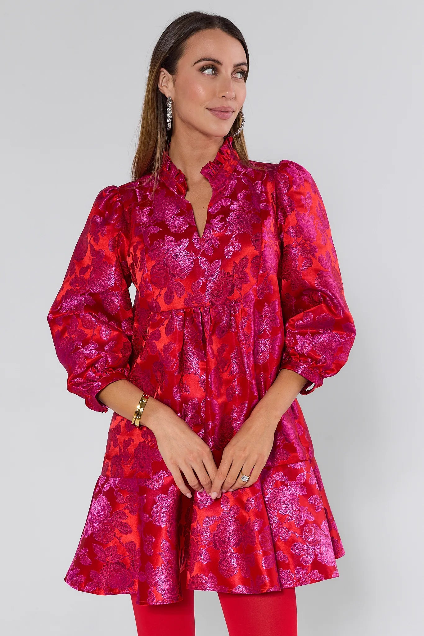 Woman wearing a vibrant Alyssa Brocade Drop Waist Dress against a white background