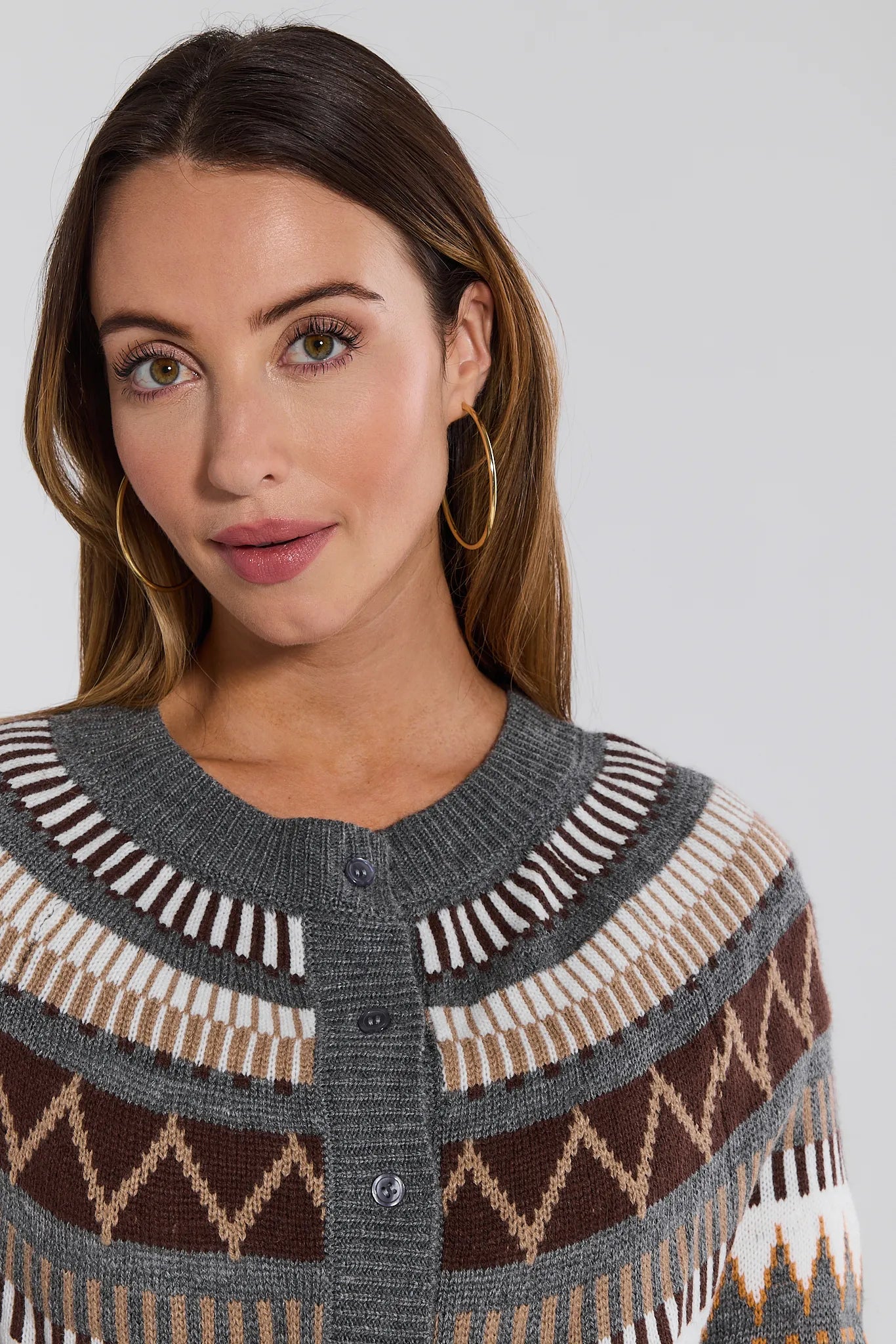 Woman wearing a patterned Alyssa Cardigan against a plain background
