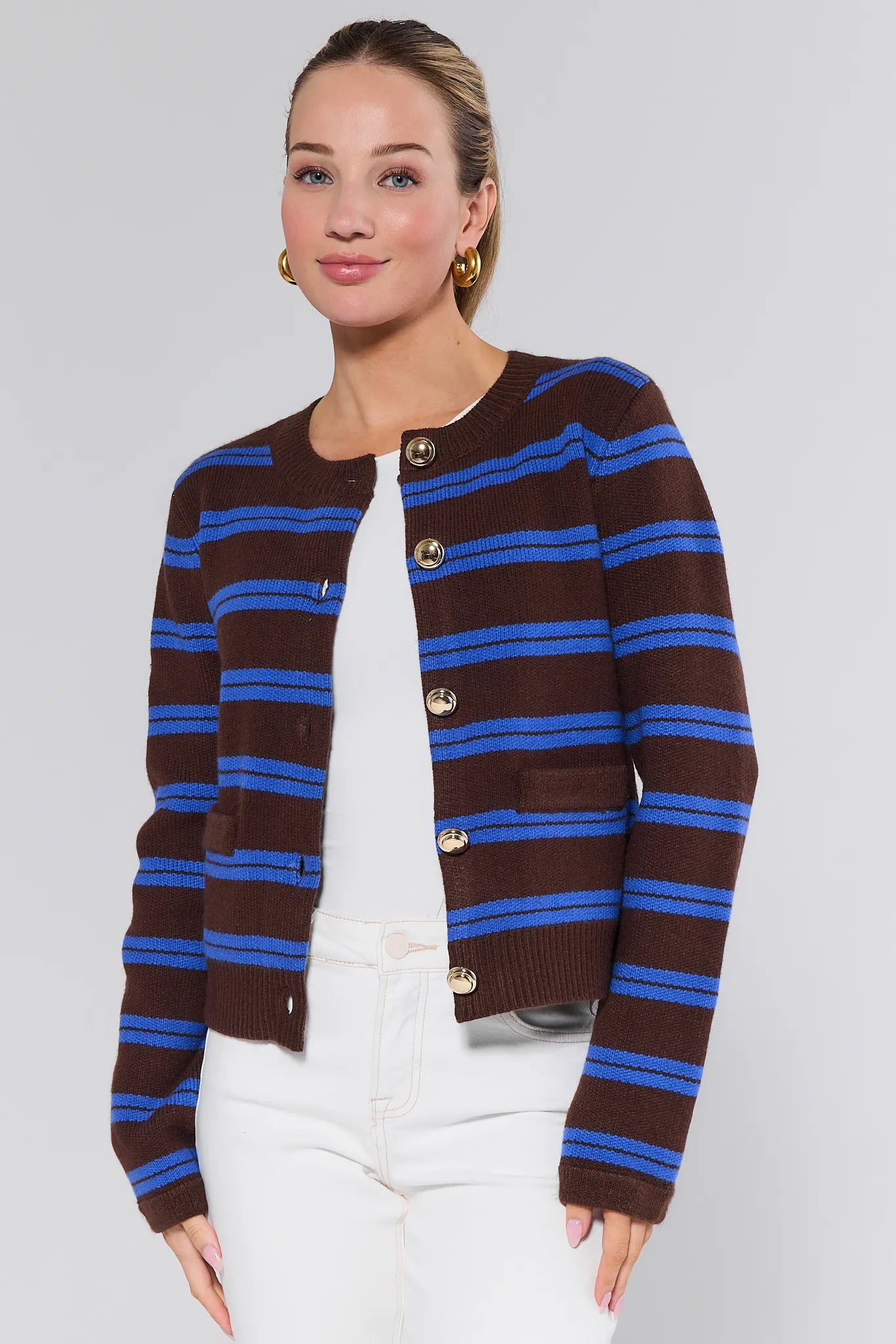 Woman wearing a brown and blue striped Chandler Cardigan on a white background