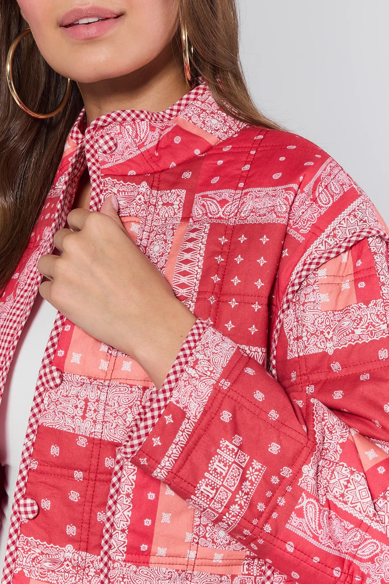Red patterned Cassidy Jacket being held up against a neutral background
