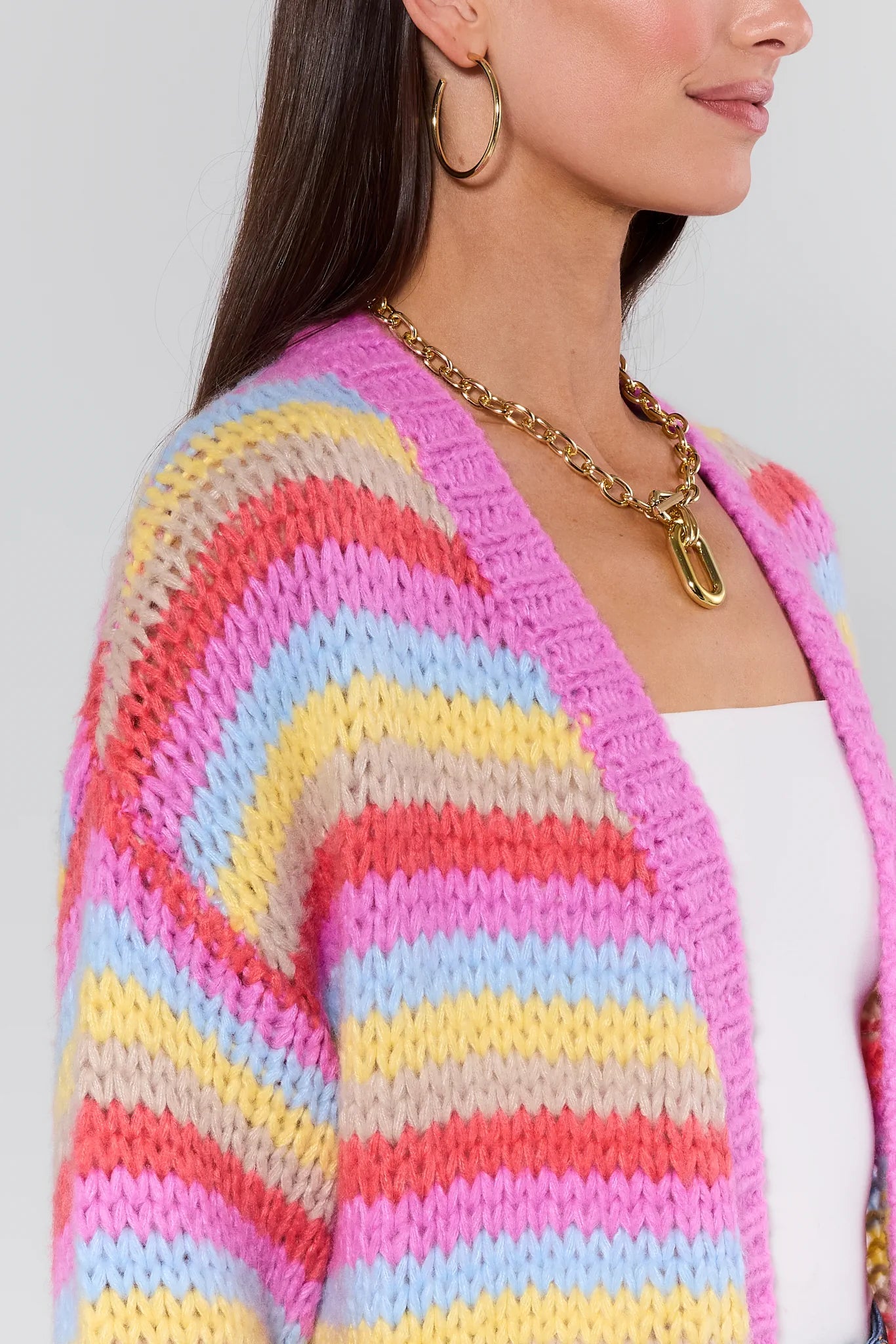 Woman wearing a Adrienne Multi Striped Knit Cardigan on a plain background