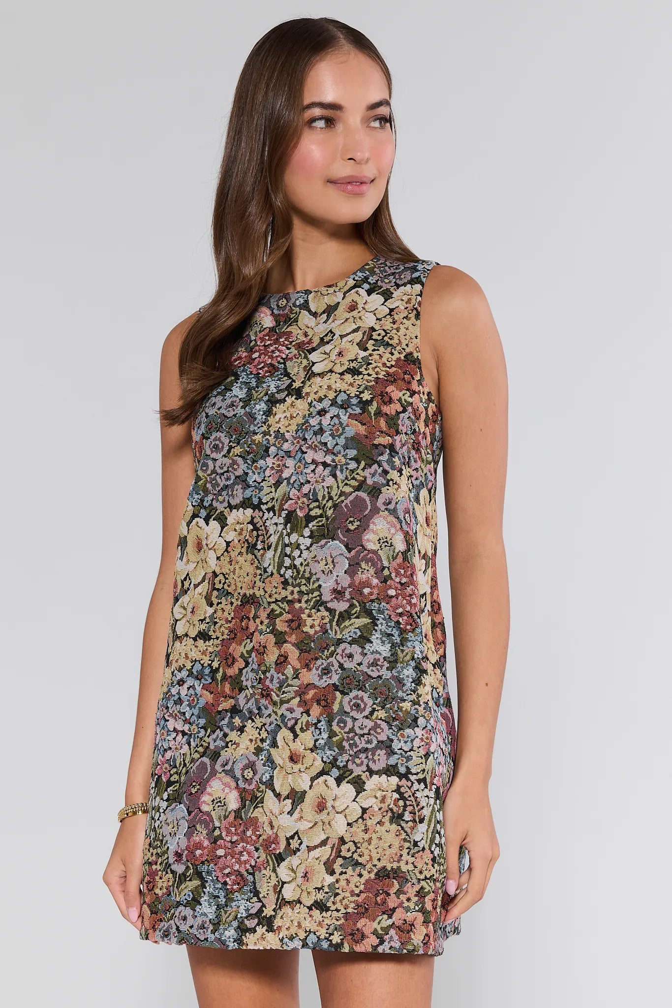 Woman wearing a floral Camdyn Dress
 against a plain background