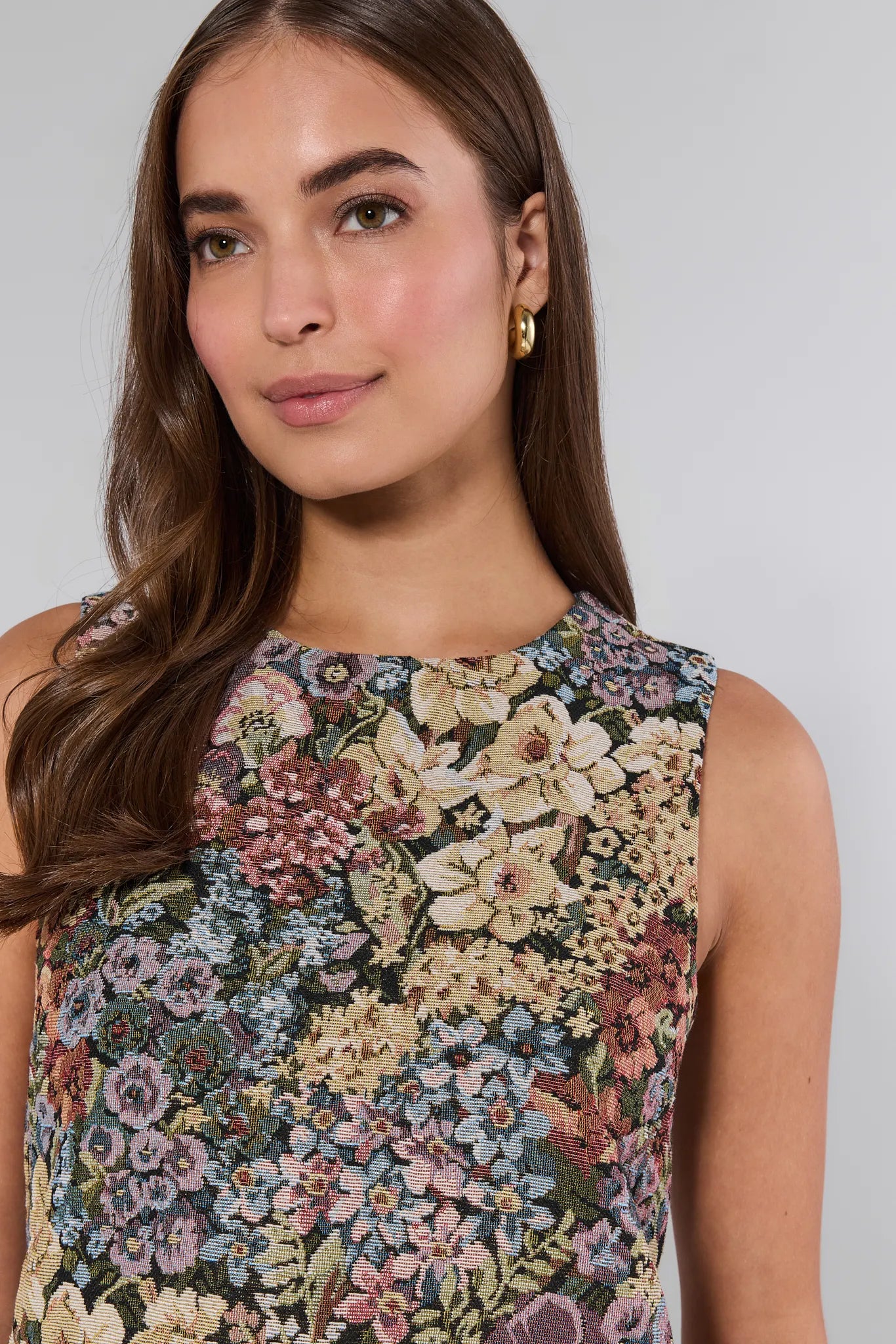 Woman wearing a sleeveless floral Camdyn Dress against a plain background