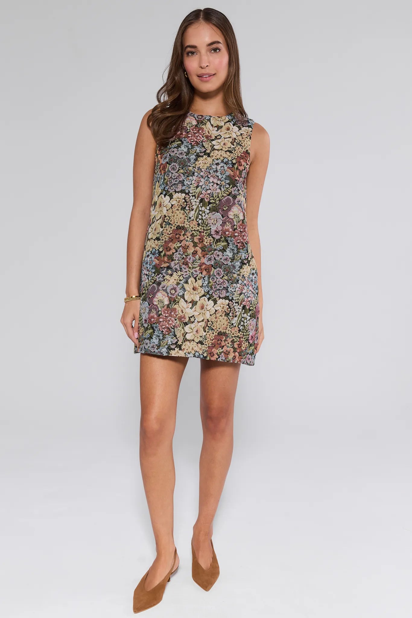 Woman wearing a floral Camdyn Dress on a white background