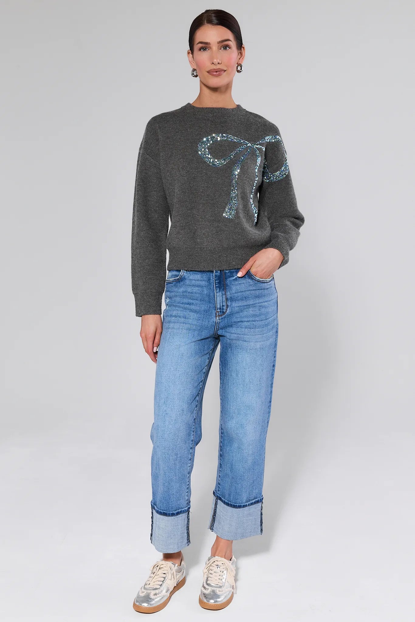 Woman wearing a Stella Grey Embellished Sweater on a plain background