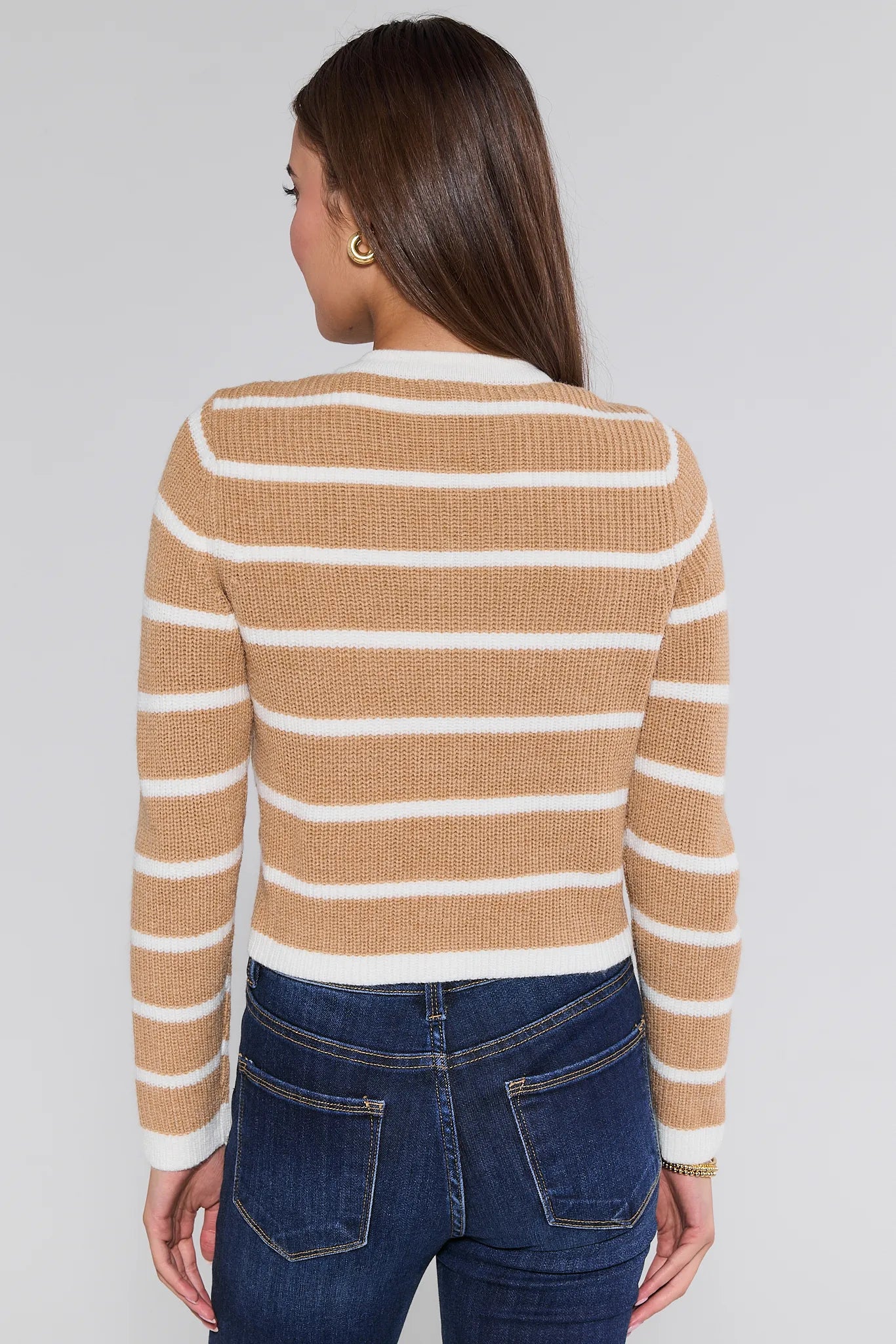 Woman wearing a striped Dayna Cardigan  and jeans against a plain background
