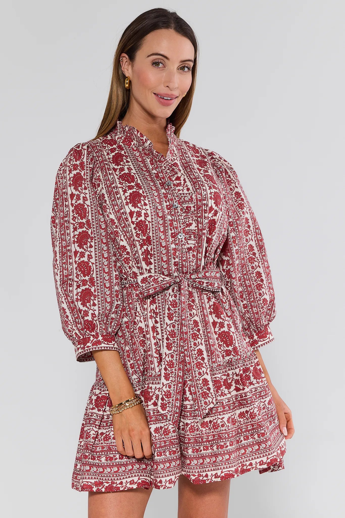 Woman wearing a red and white patterned Morgan Dress on a gray background