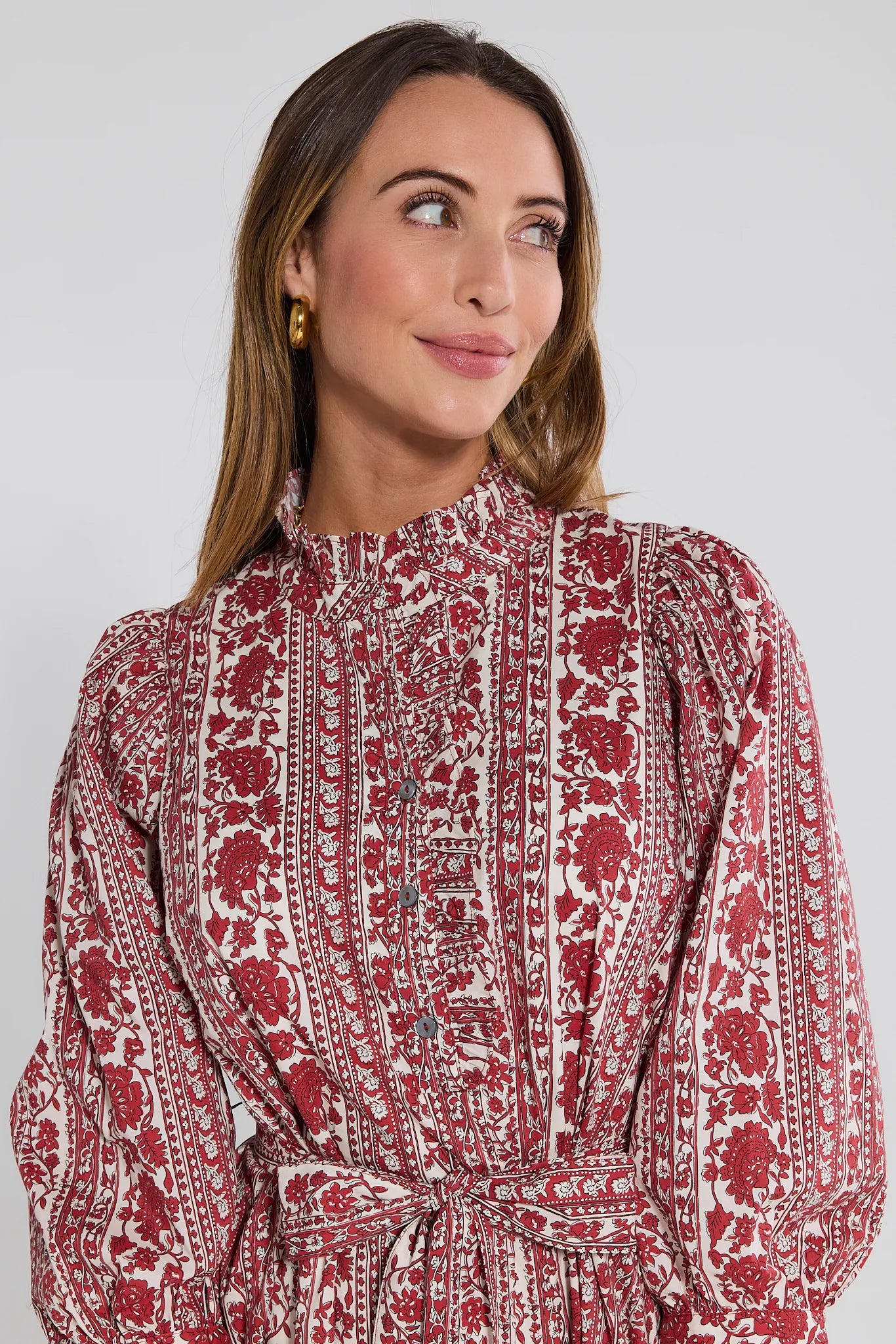 Woman wearing a red and white patterned Morgan Dress against a plain background