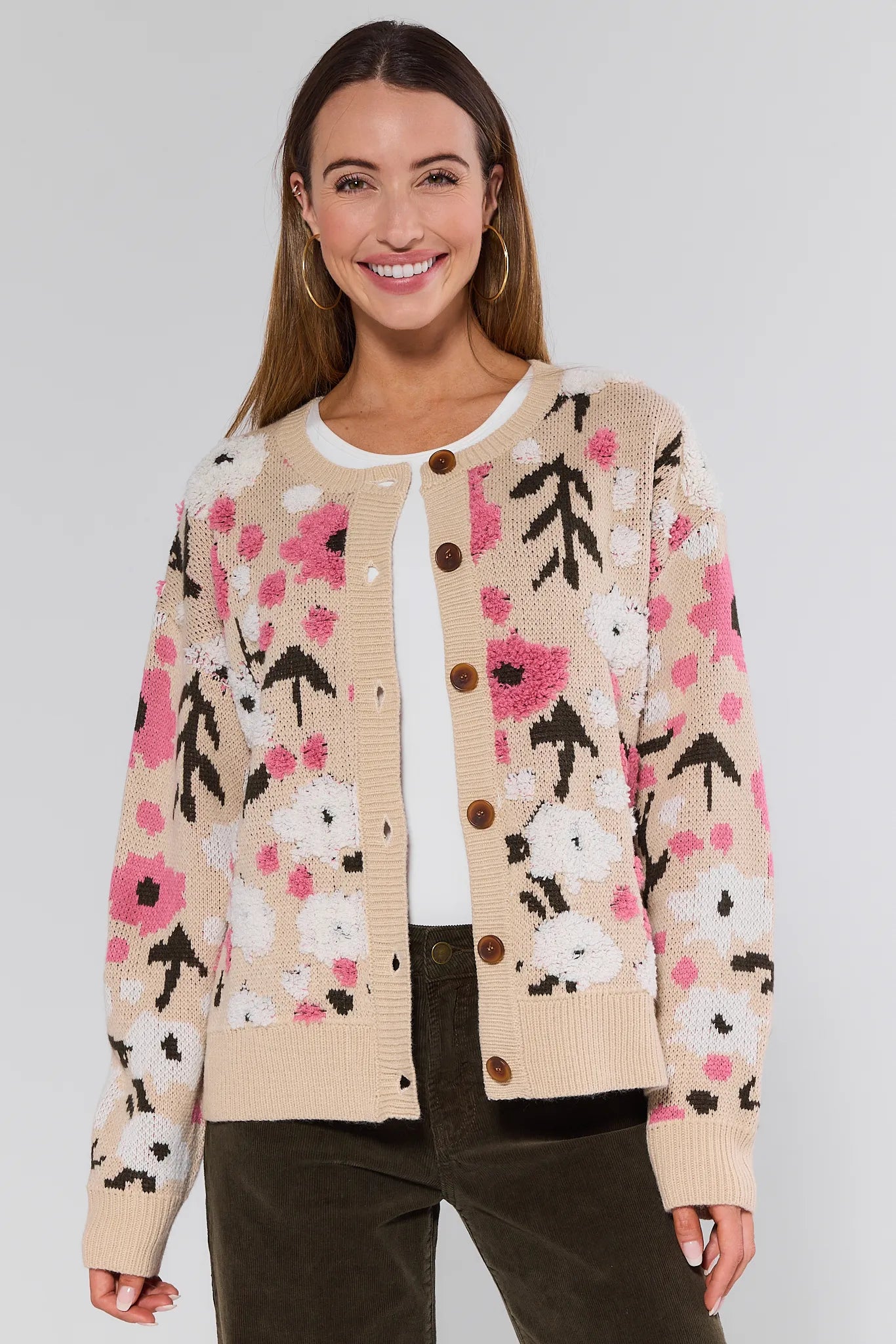 Woman wearing a floral patterned Norah Cardigan on a plain background