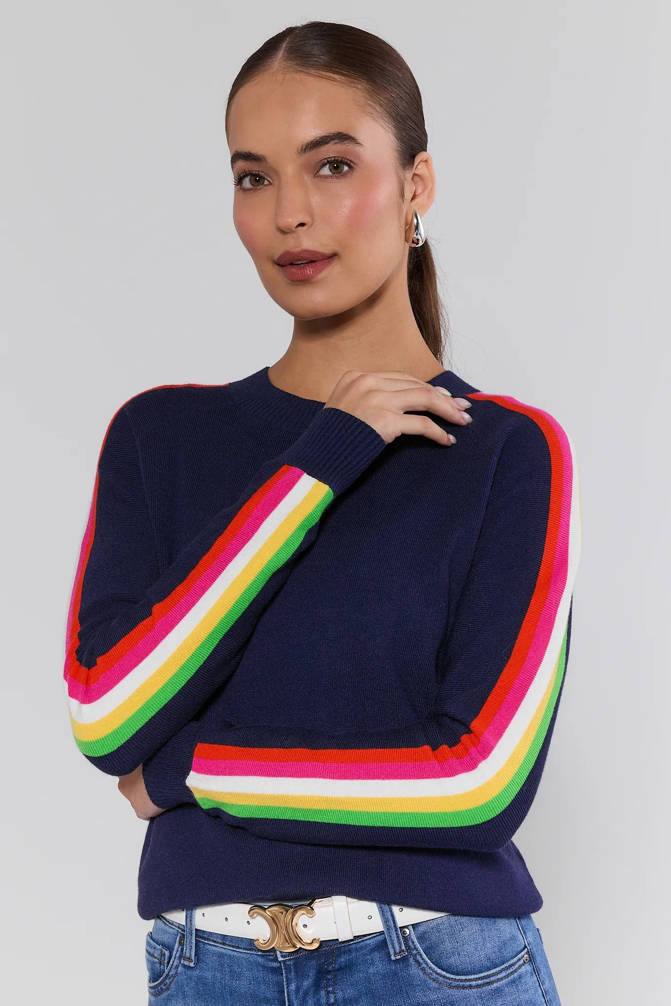 Woman wearing a navy sweater with colorful stripes on a plain background Khloe Navy Striped Sleeve Sweater