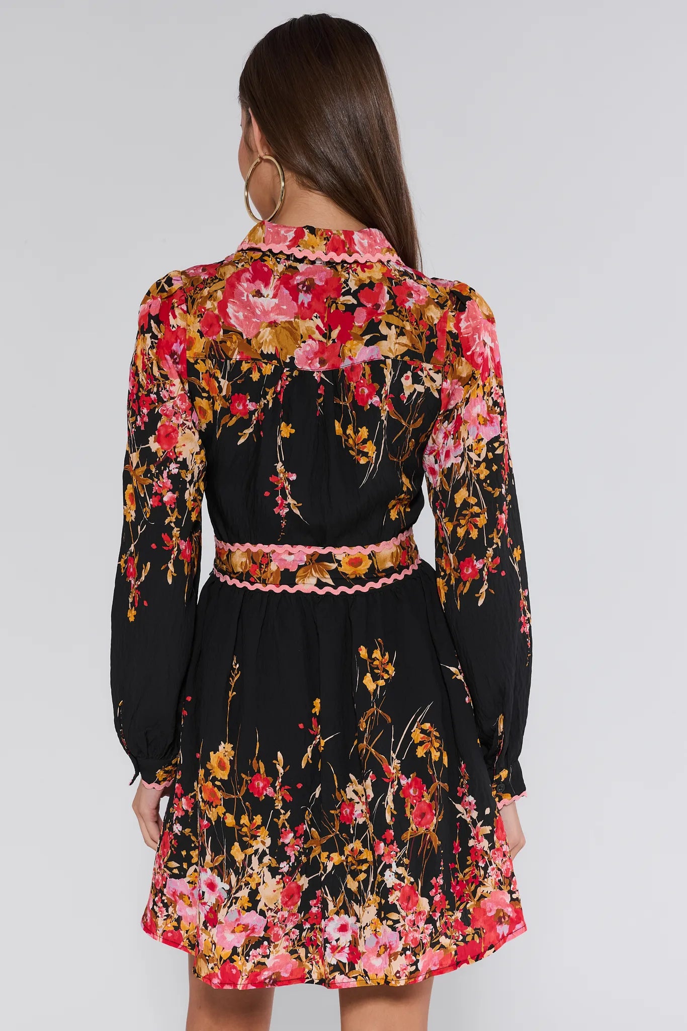 Woman wearing a black floral Faye Dress with a white background