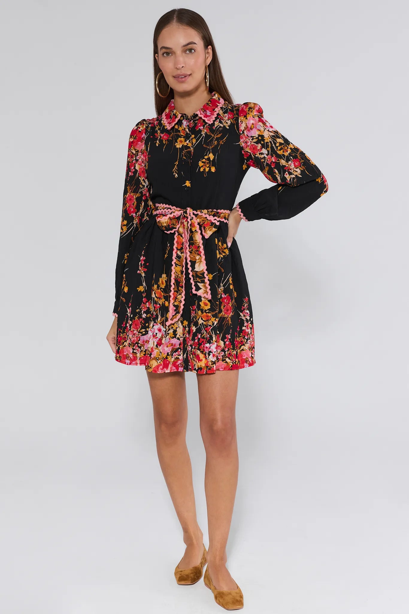 Woman wearing a black Faye Dress with colorful floral pattern on a white background