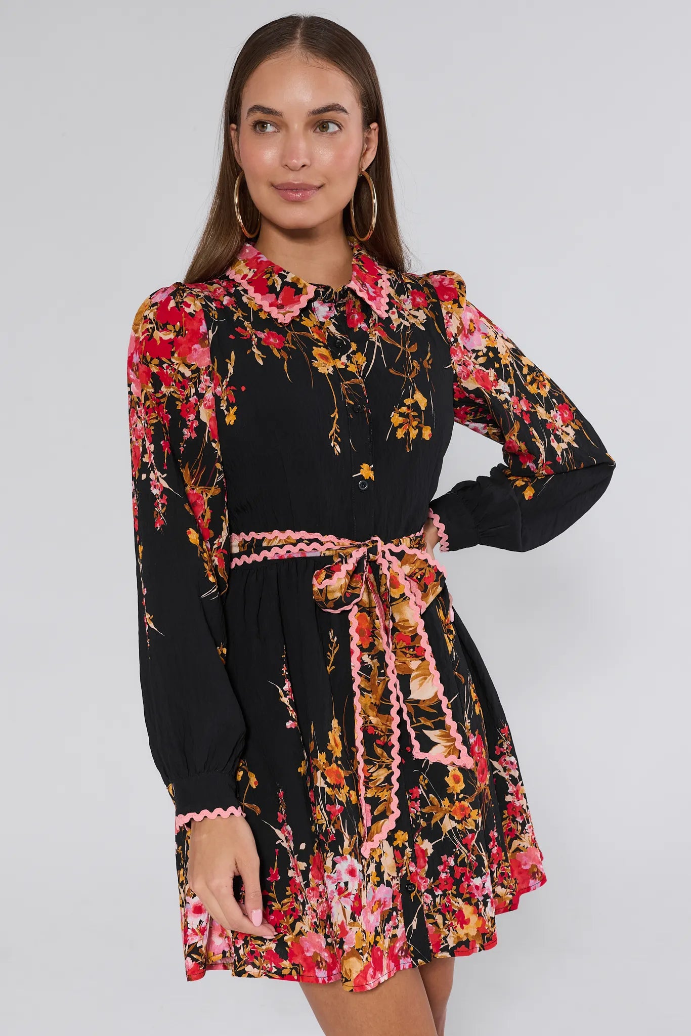 Woman wearing a black floral Faye Dress with a white background