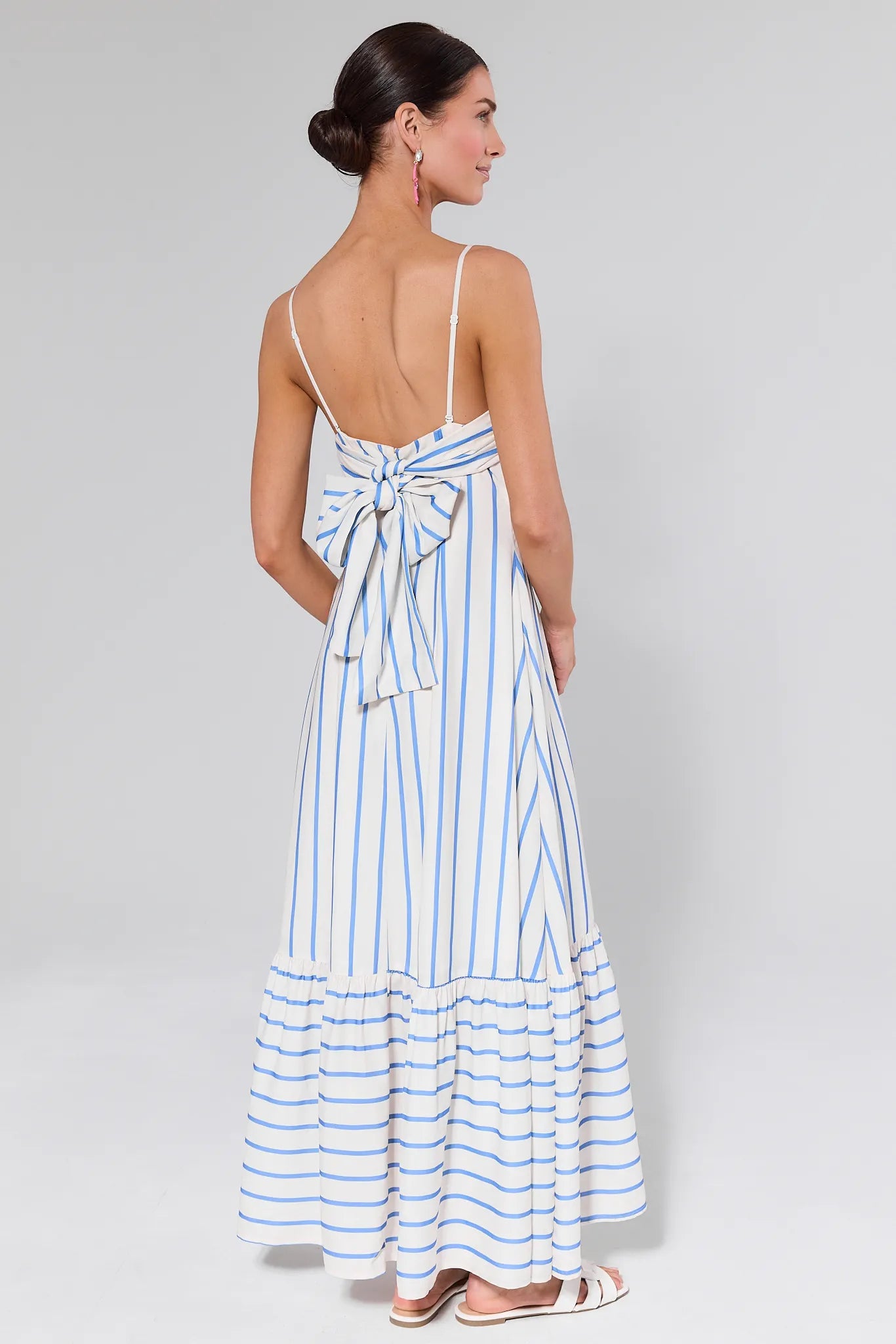 Woman wearing a Finley Striped Maxi Dress on a gray background