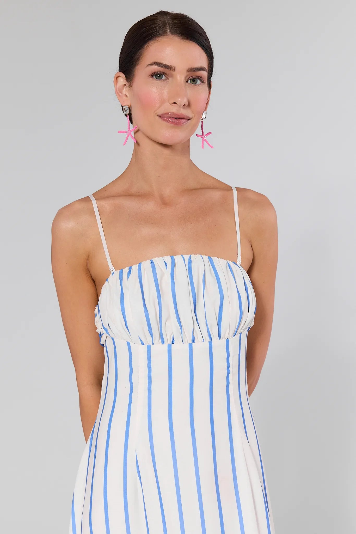 Woman wearing a Finley Striped Maxi Dress on a gray background