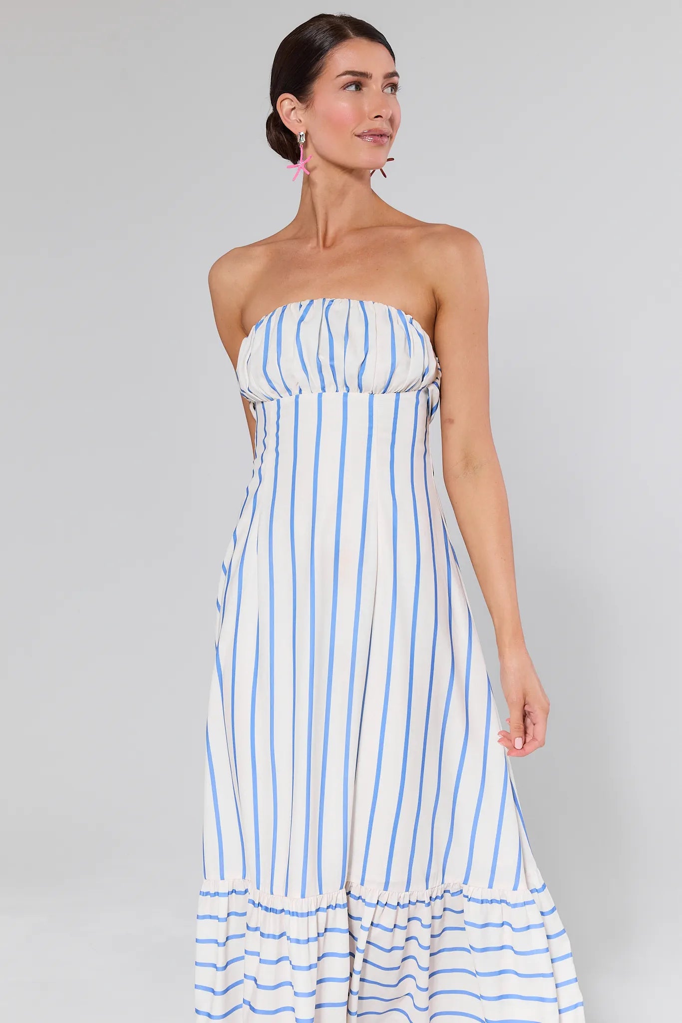 Woman wearing a Finley Striped Maxi Dress on a gray background