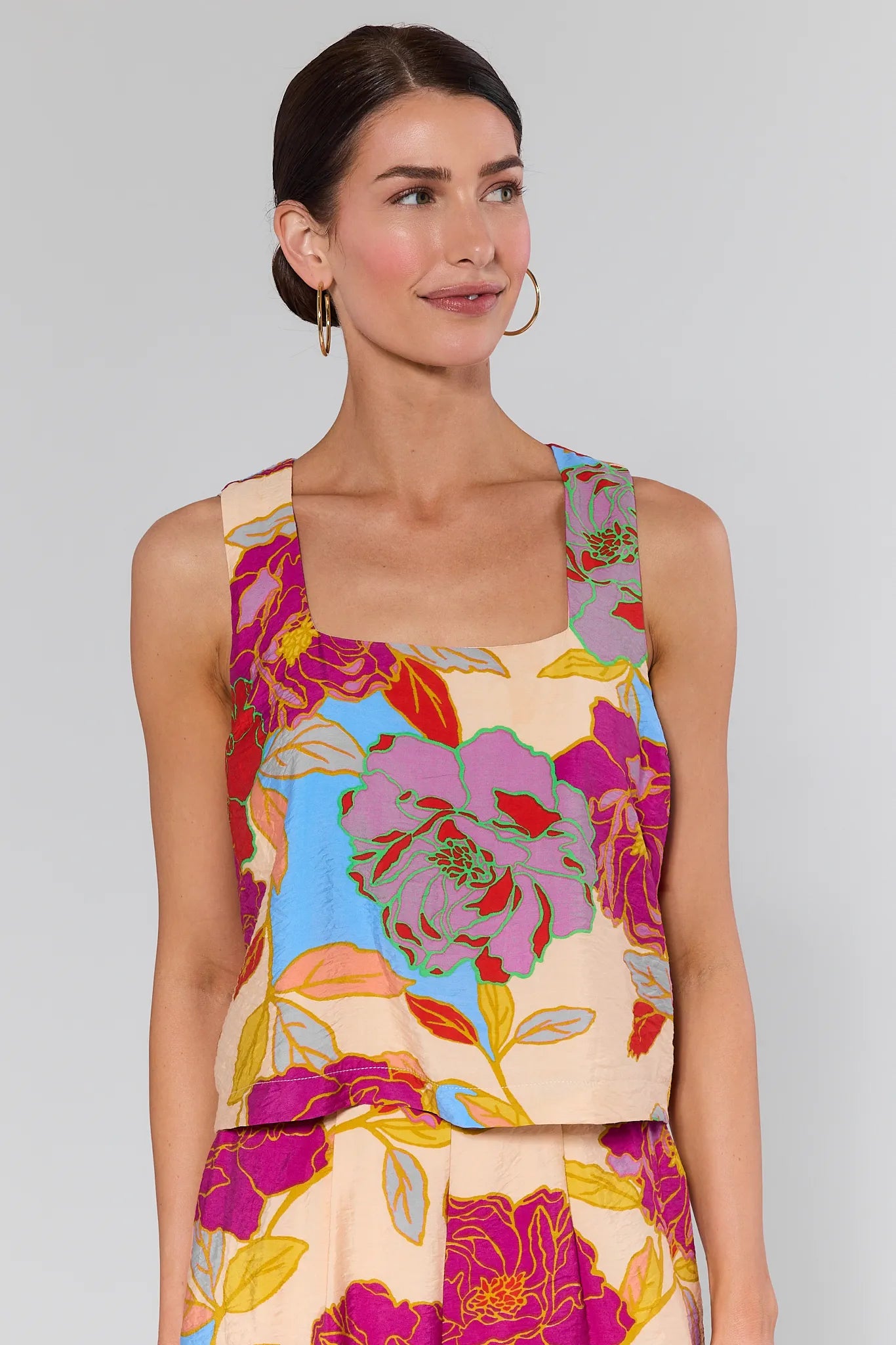 Woman wearing a Marisol Multicolor Floral Tank Top against a plain background