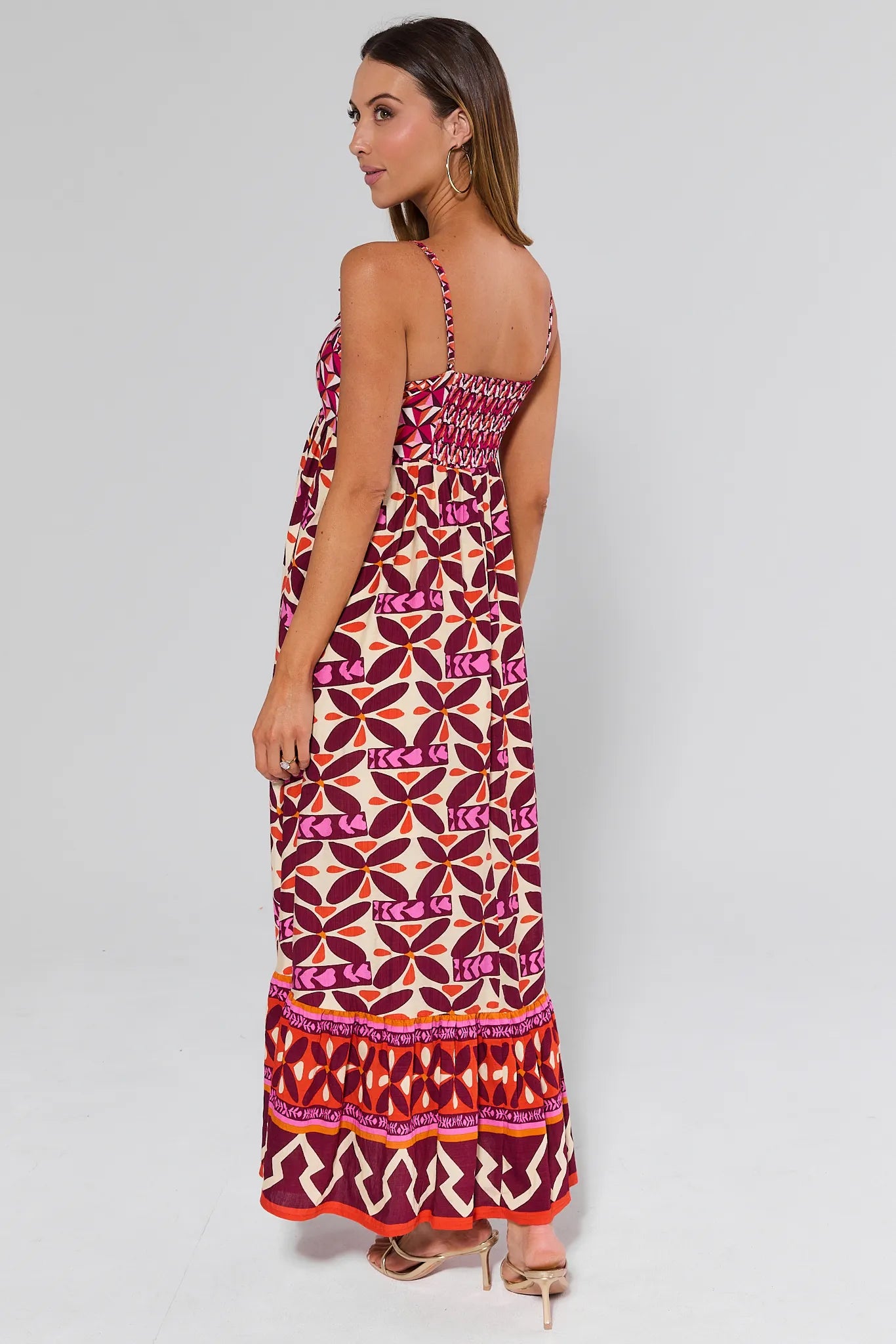 Woman wearing a Jackie Pink Printed Midi Dress on a plain background
