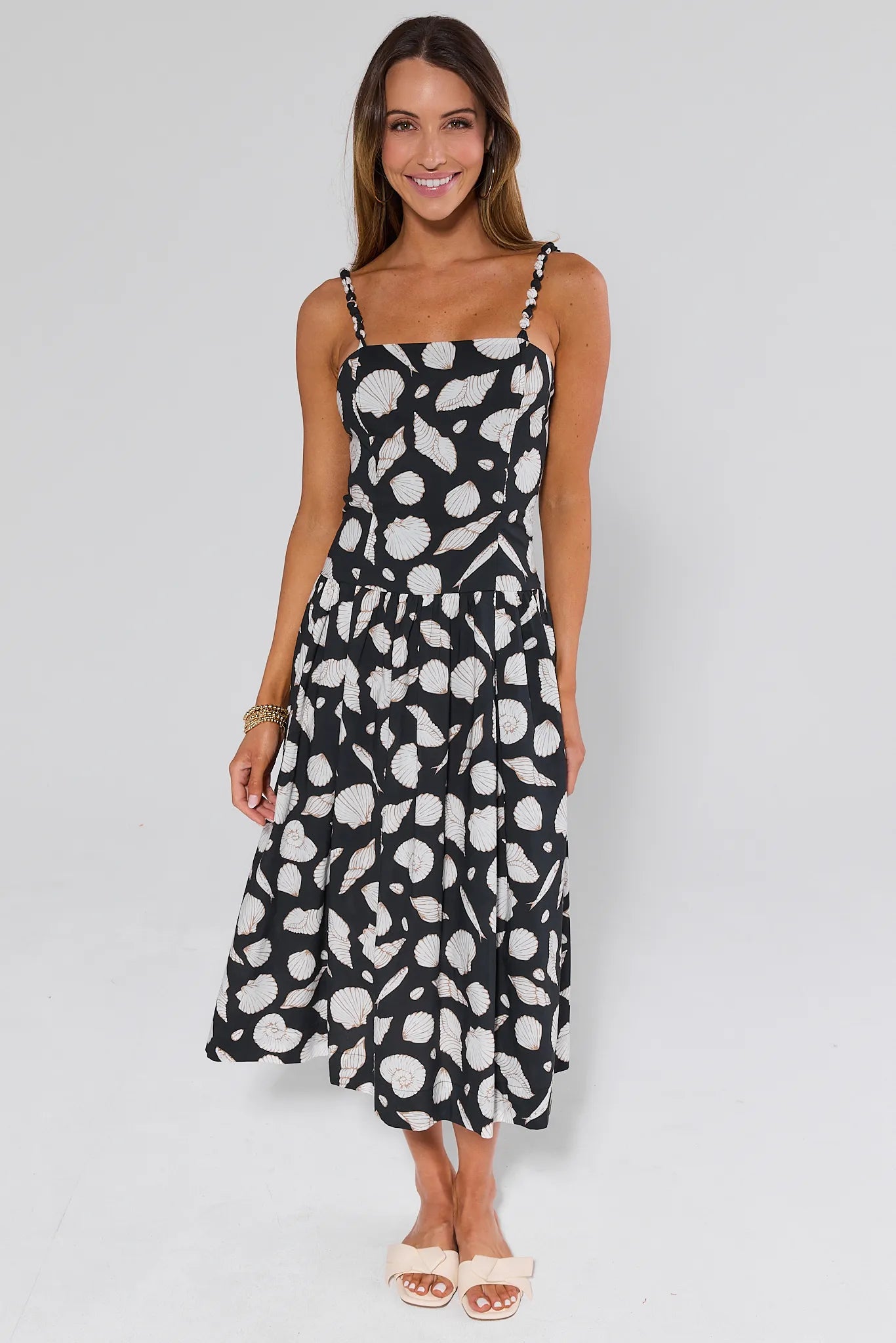 Woman wearing a black and white Capri Seashell Maxi Dress on a gray background