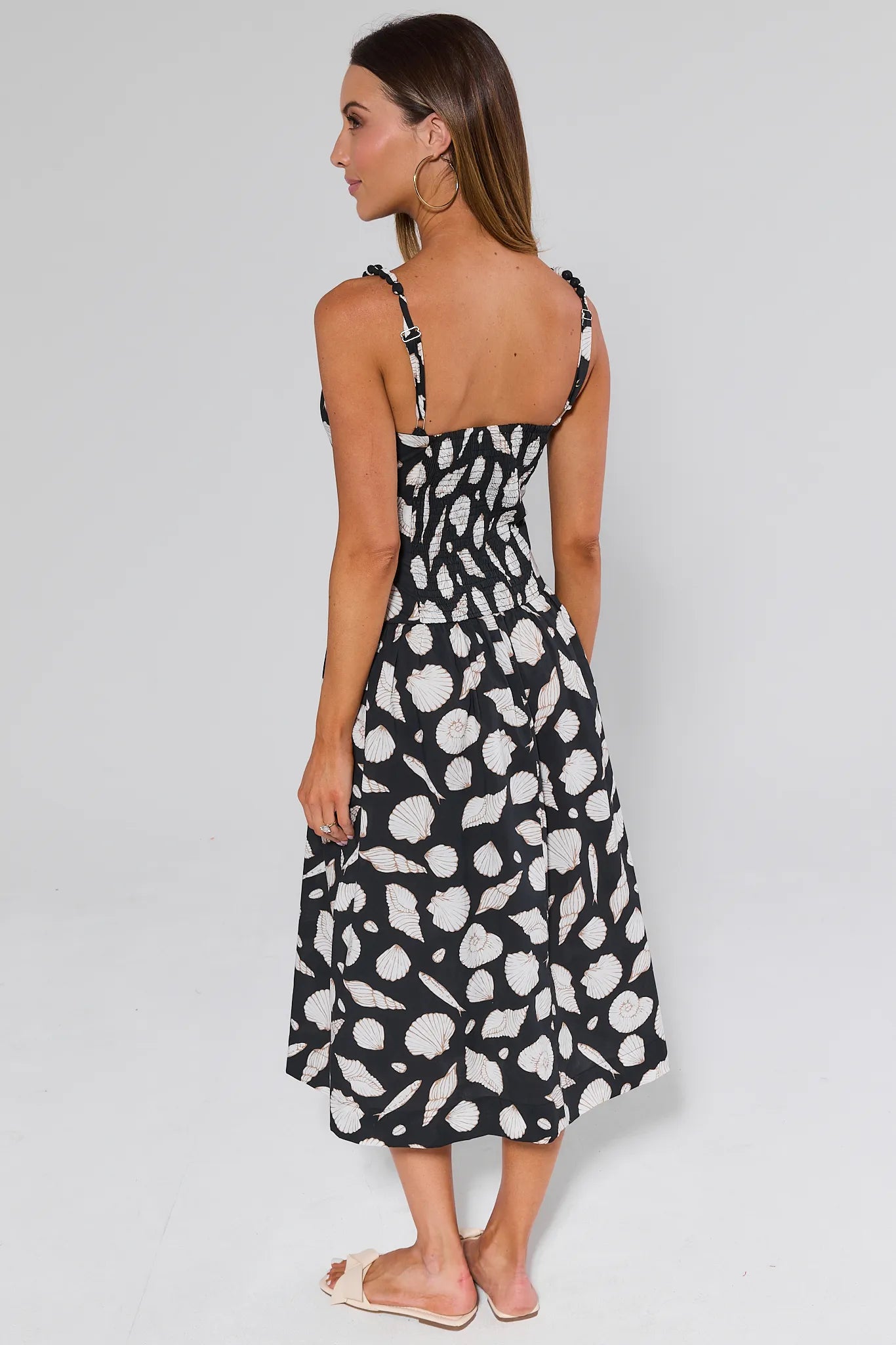 Woman wearing a Capri Seashell Maxi Dress on a white grey background