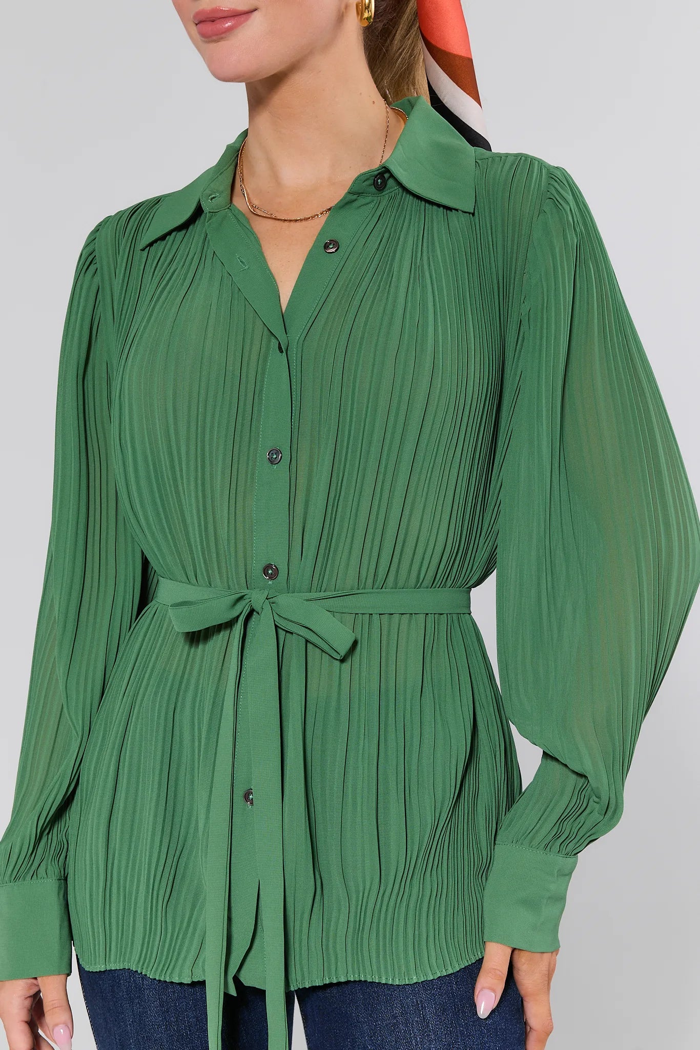 Green pleated Miley Top with a belt worn by a person on a plain background