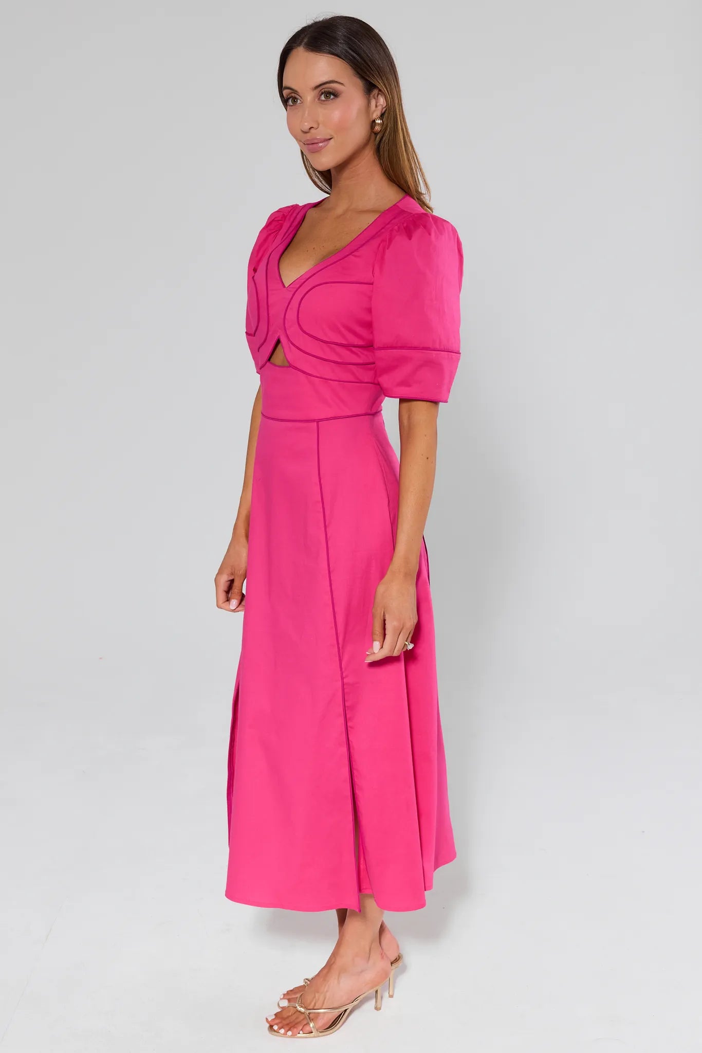 Woman wearing a Andrea Pink Maxi Dress on a light gray background
