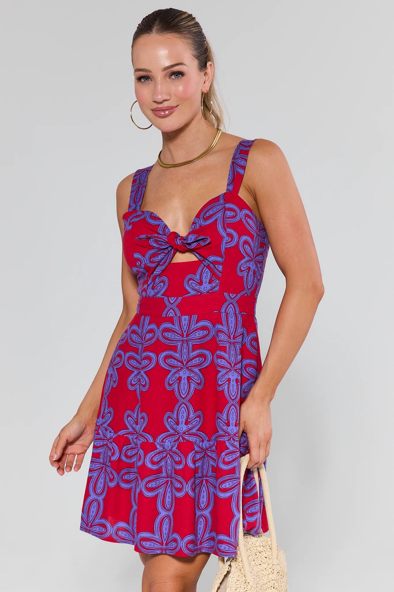 Woman wearing a Clarissa Multi Printed Mini Dress against a plain background