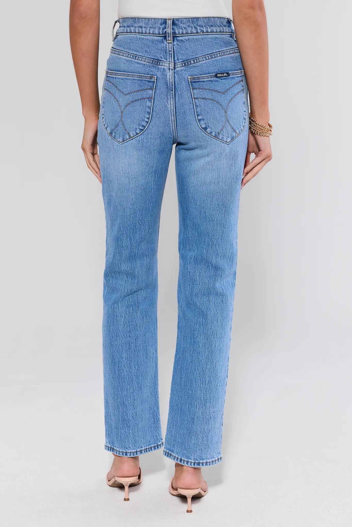 Lou Light Wash Straight Leg Jeans by Rolla's, shown from the back, paired with nude sandals, featuring comfort-stretch denim and a tailored fit.