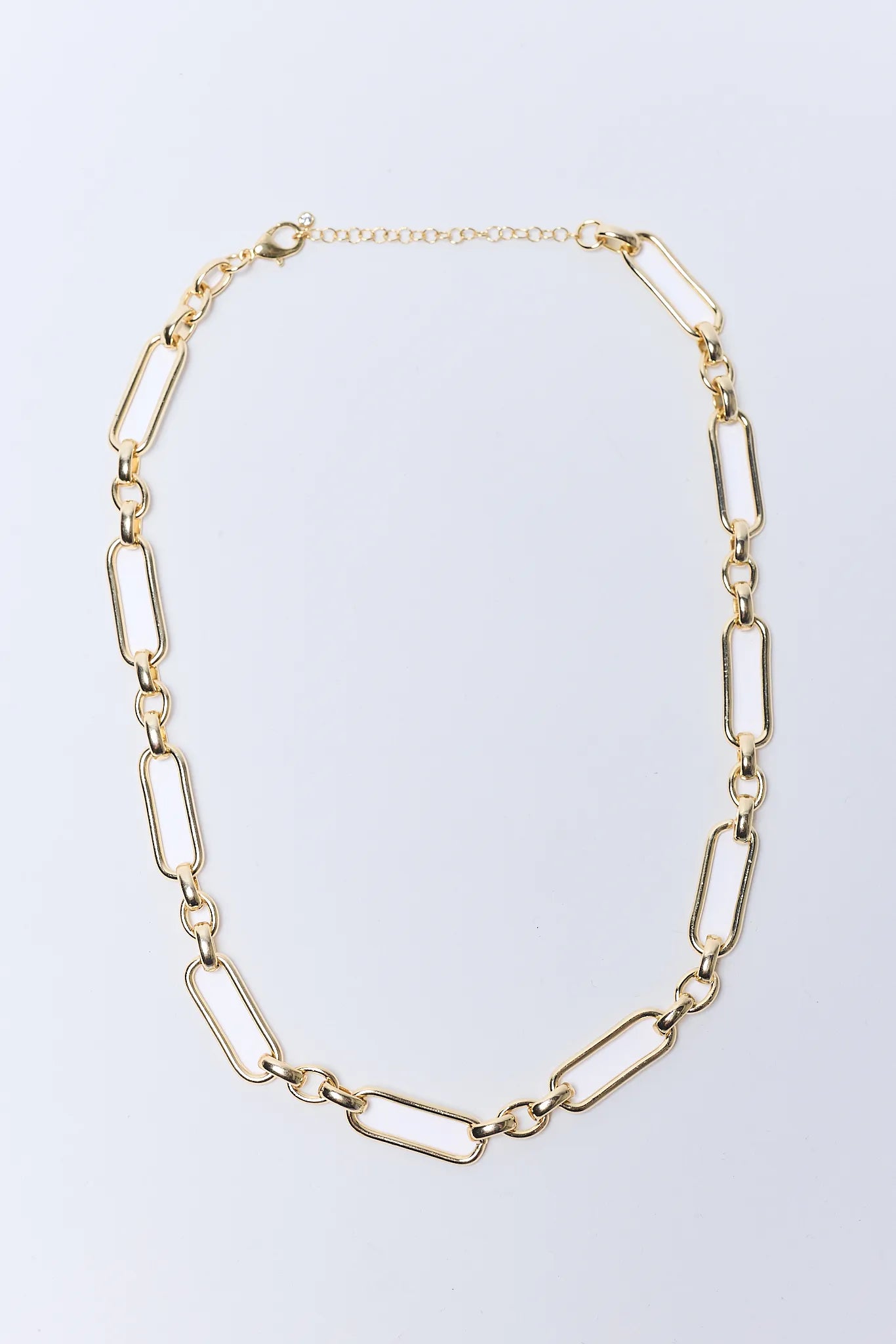 Gold chain Aster Necklace on a light gray background