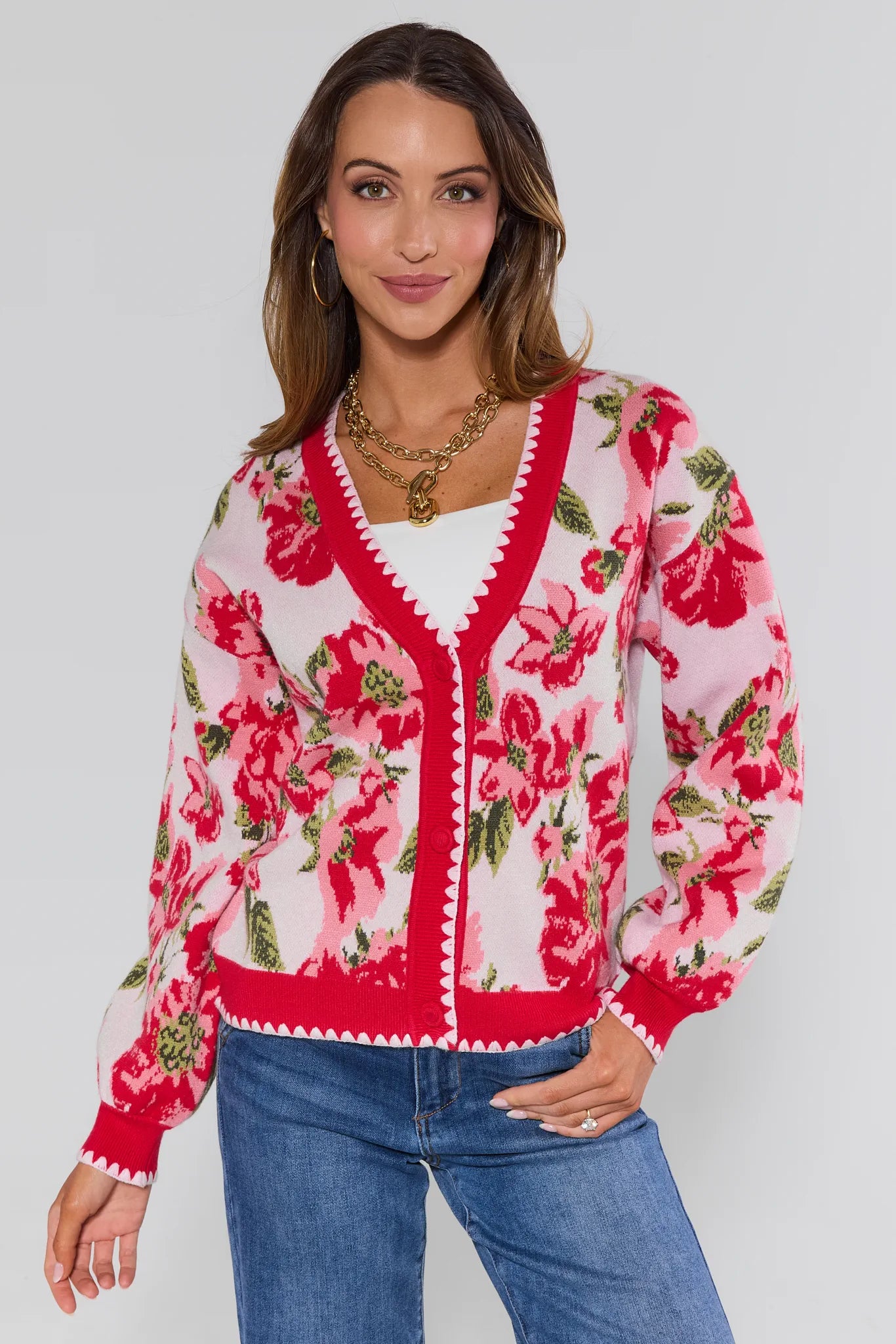 Woman wearing a floral cardigan with a white background