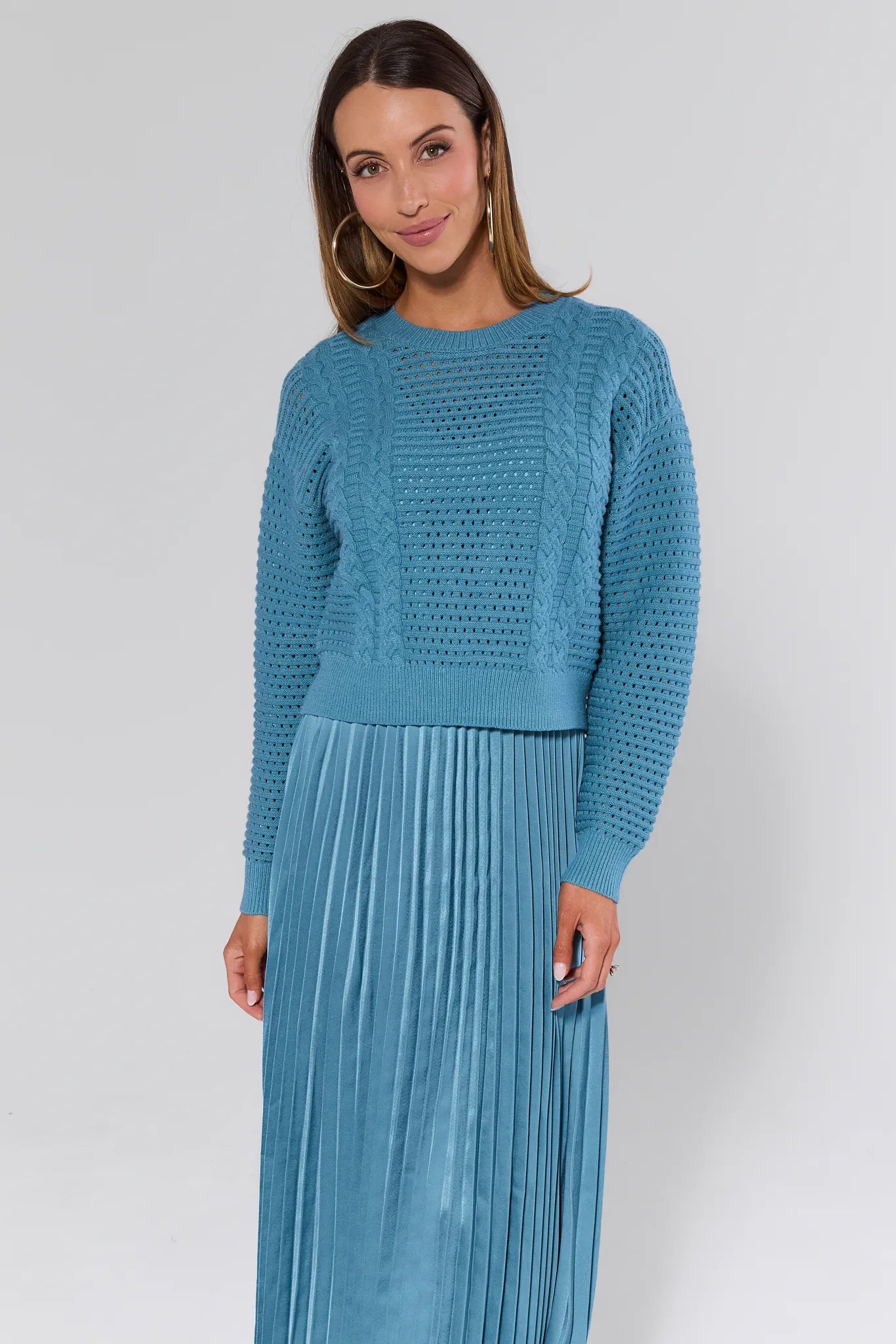 Woman wearing a Gabbie Dusty Blue Midi Dress on a white background