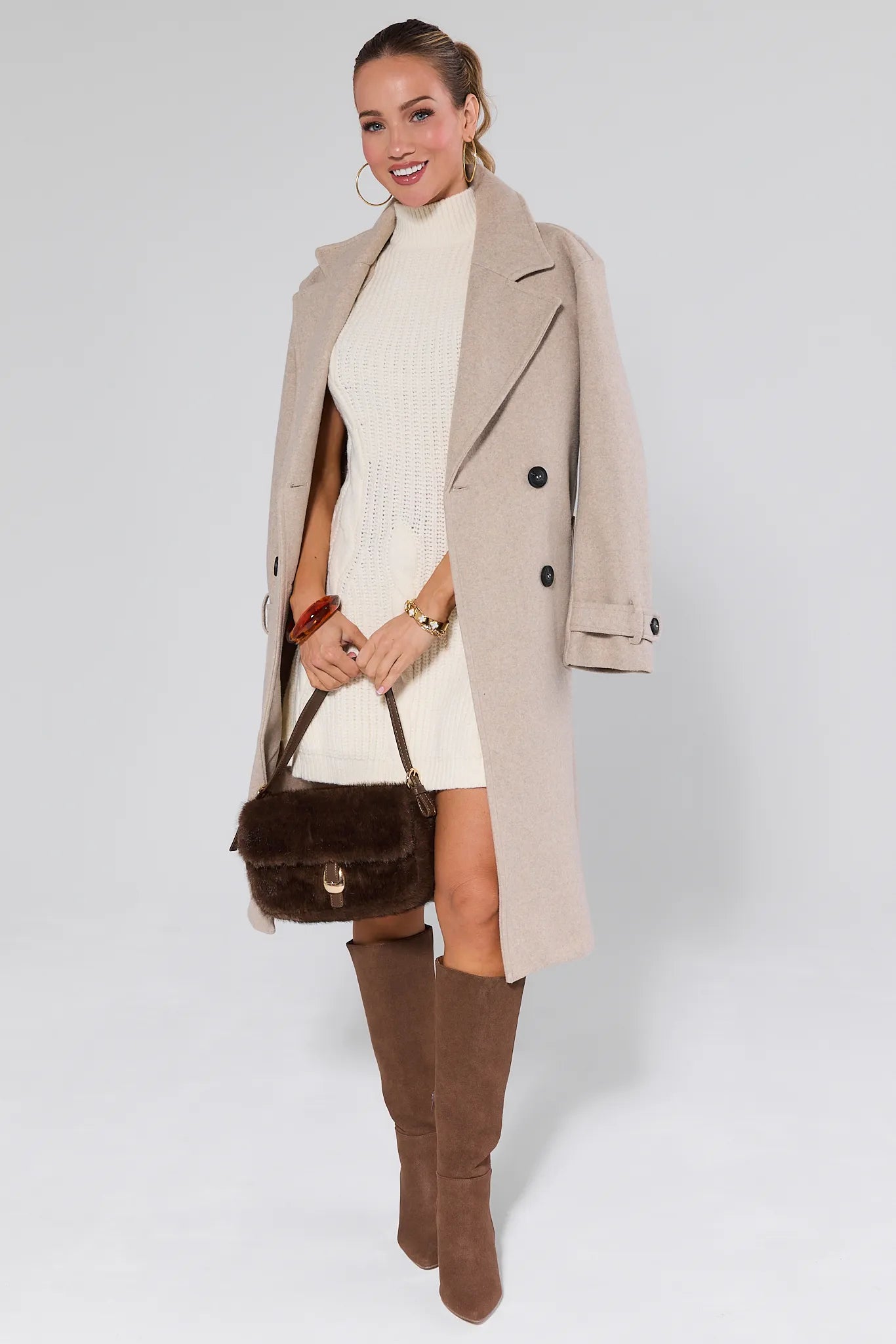 Woman wearing a Mila Ivory Knit Sweater Dress against a plain background