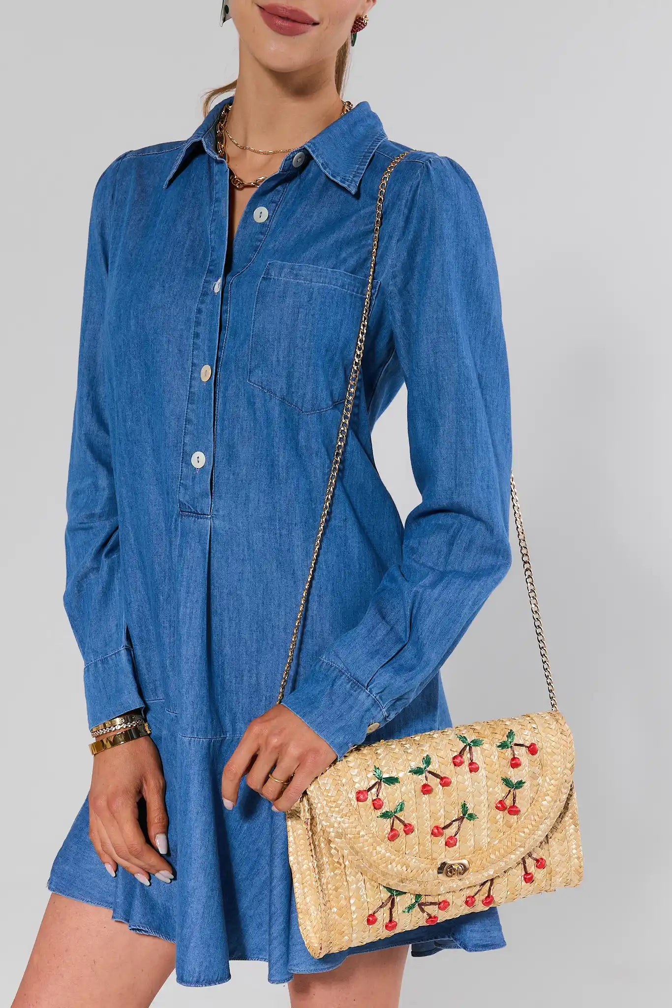 woman wearing Colette Woven Raffia Cherry Clutch