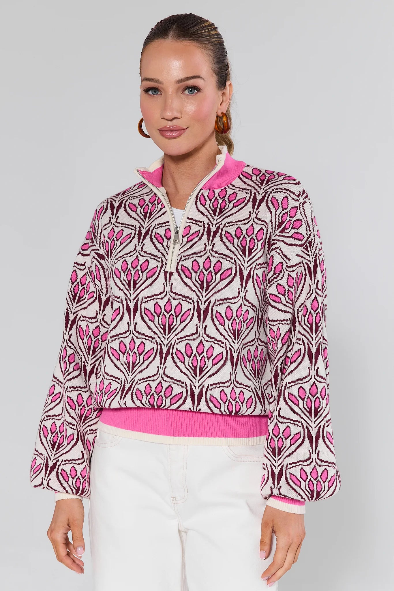Woman wearing a Preston Pink Half Zip Sweater on a white background