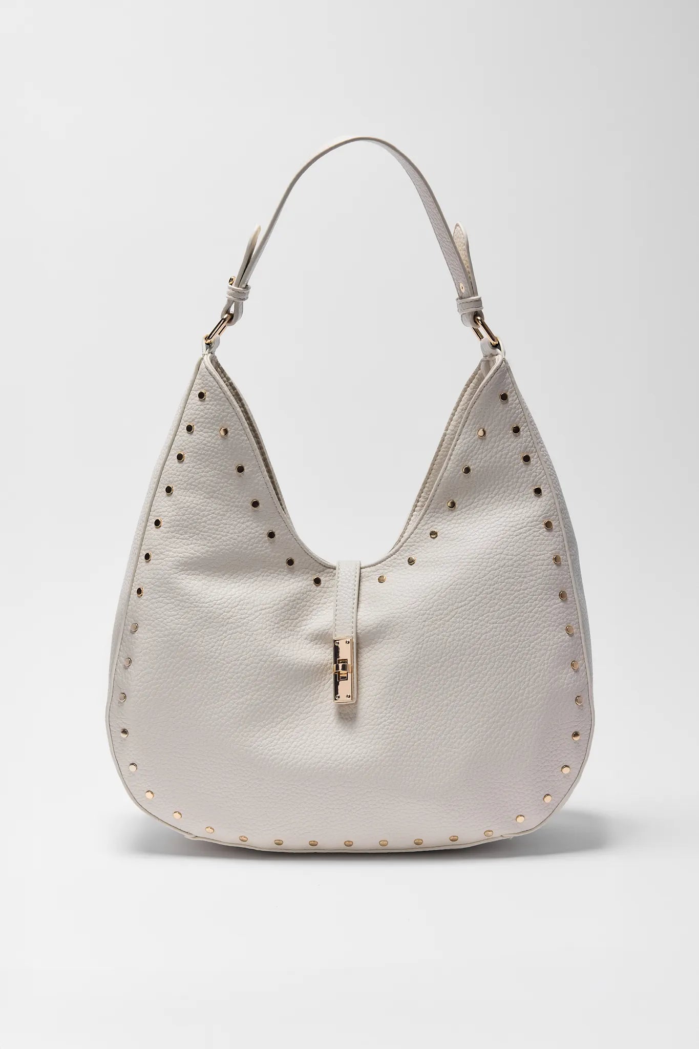 White handbag with studded details on a light gray background
