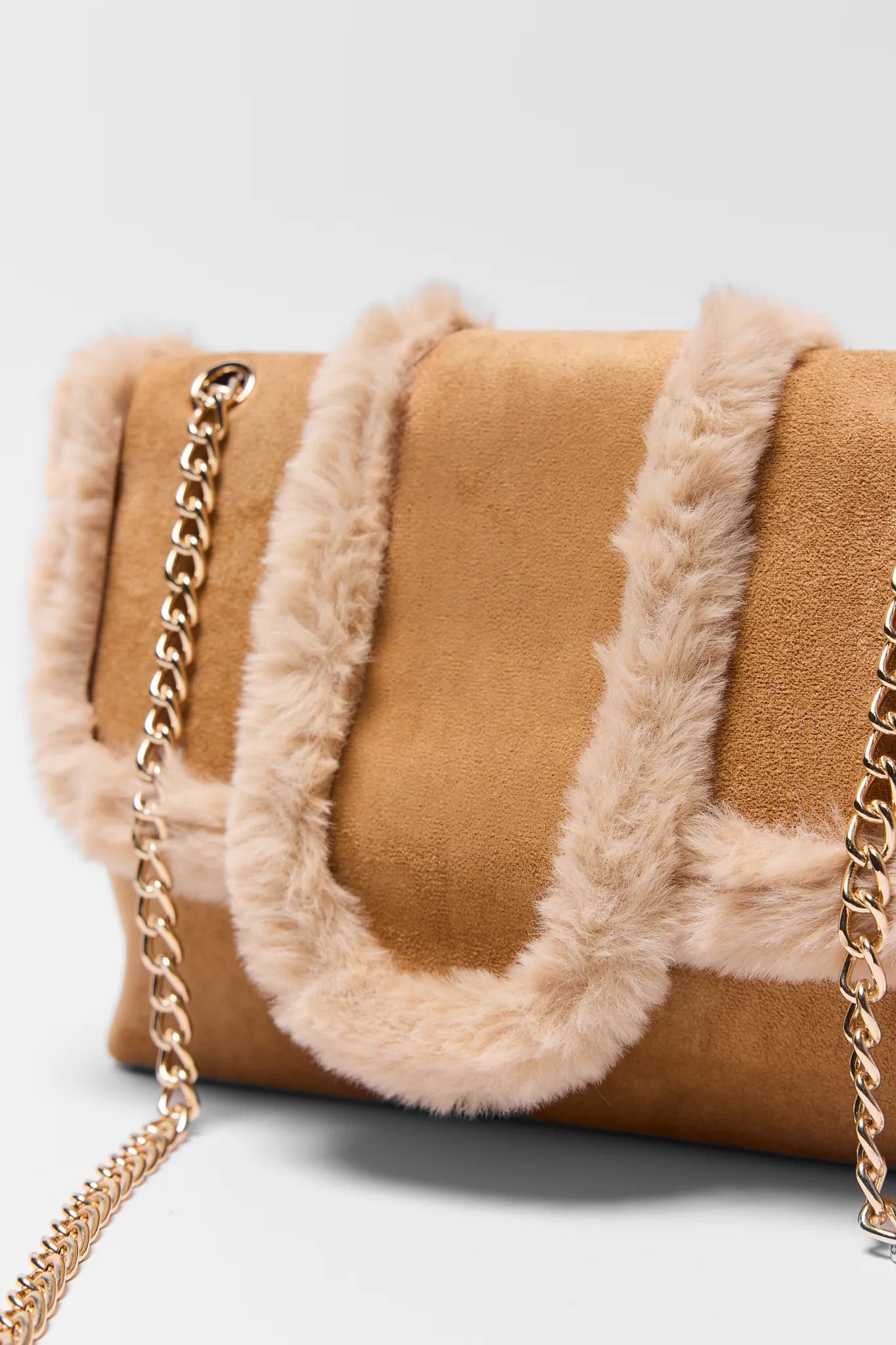Brown handbag with beige fur accents and a gold chain on a white background Tori Tan Suede Shoulder Bag