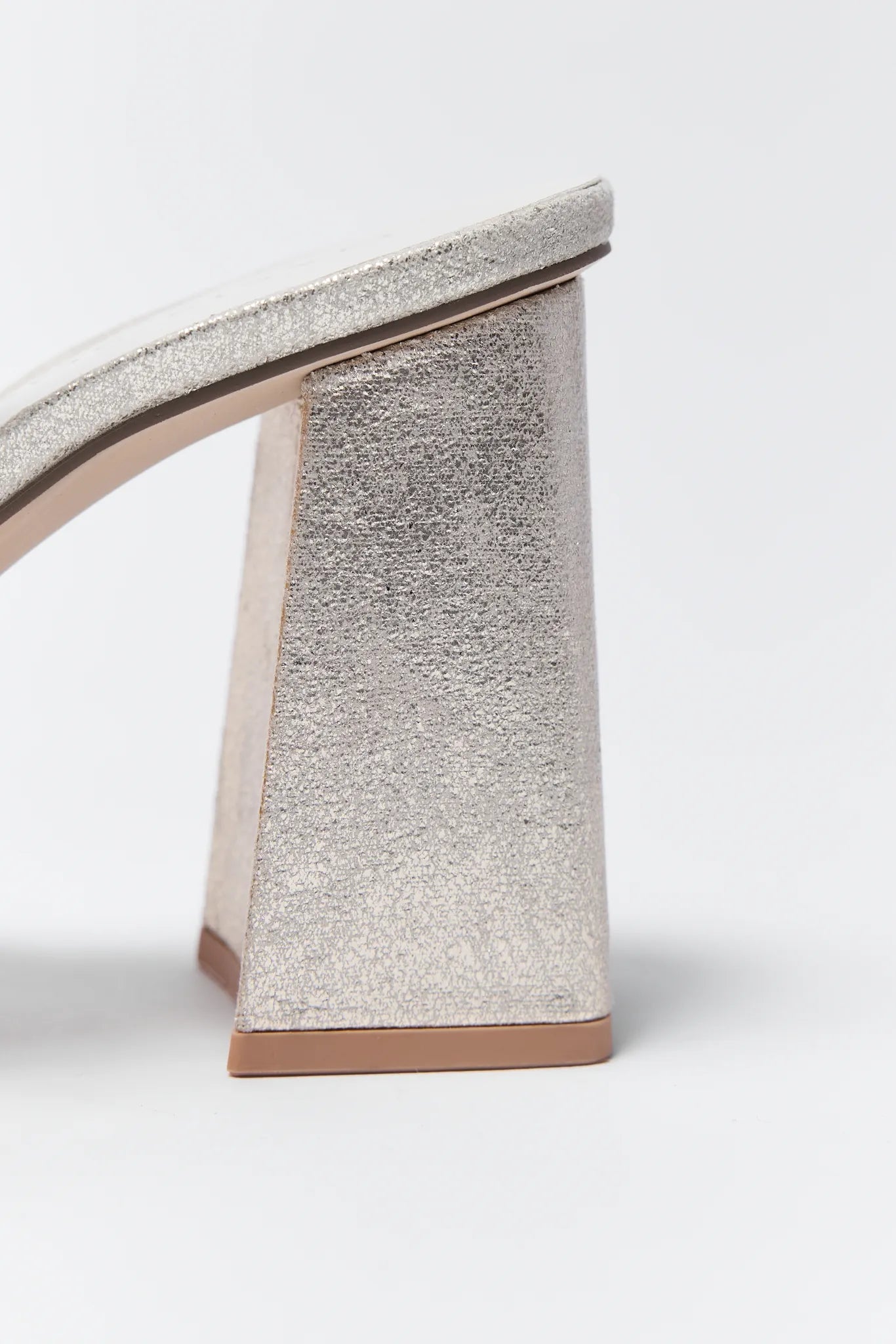 Pair of Zoey Gold Platform Heels with bow details on a white background