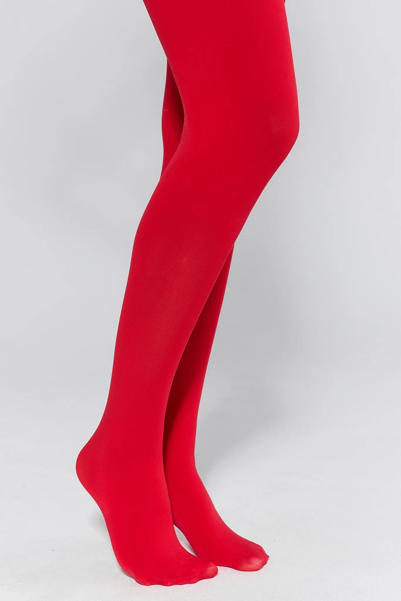 Red tights worn by a person on a white background