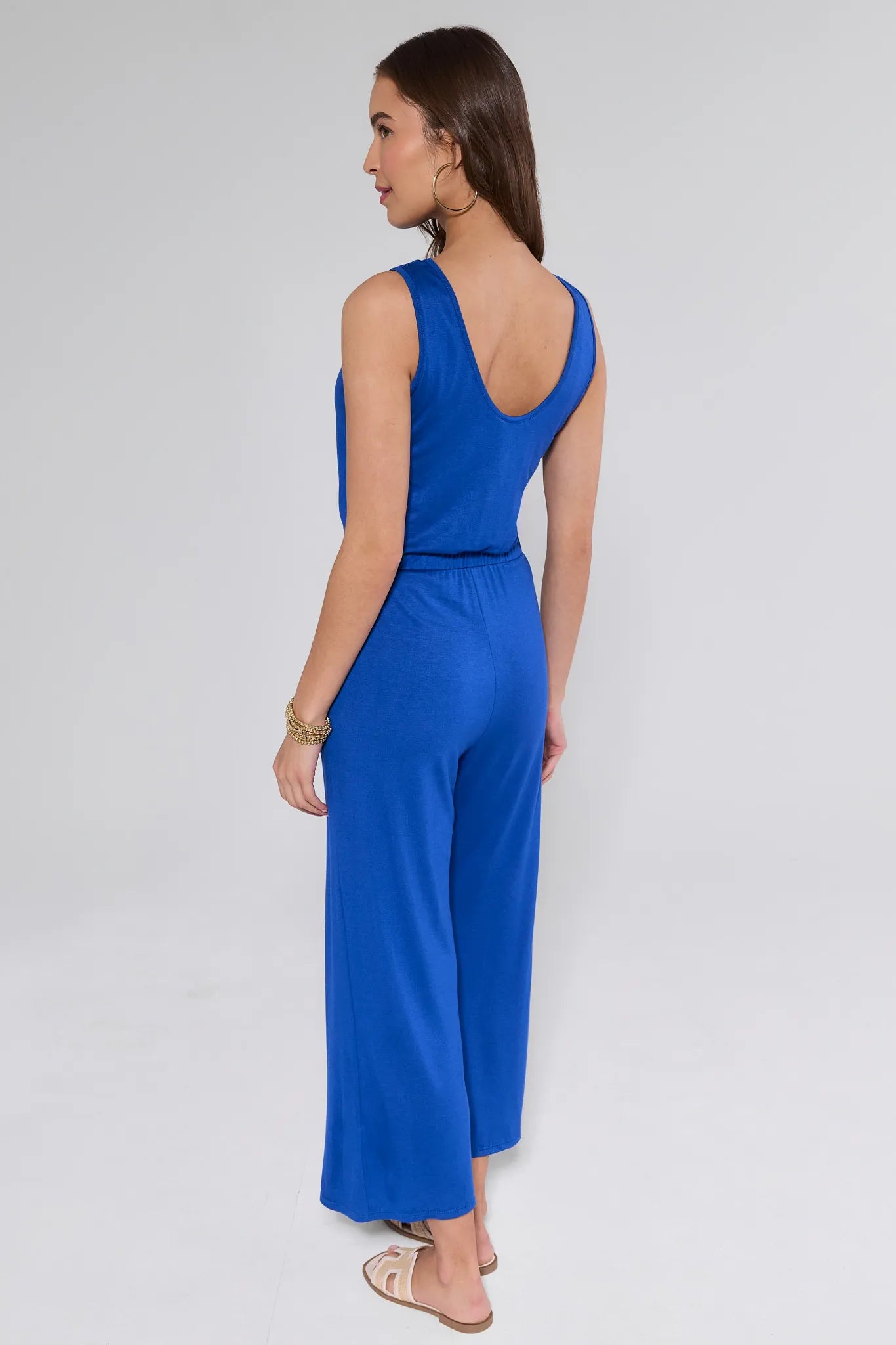 Woman wearing a blue jumpsuit on a white background