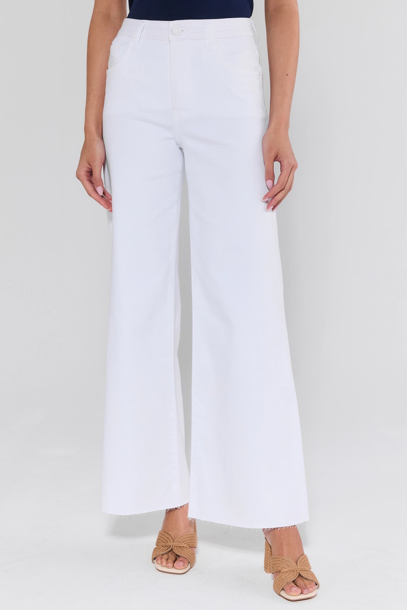 White wide-leg pants worn by a person on a white background