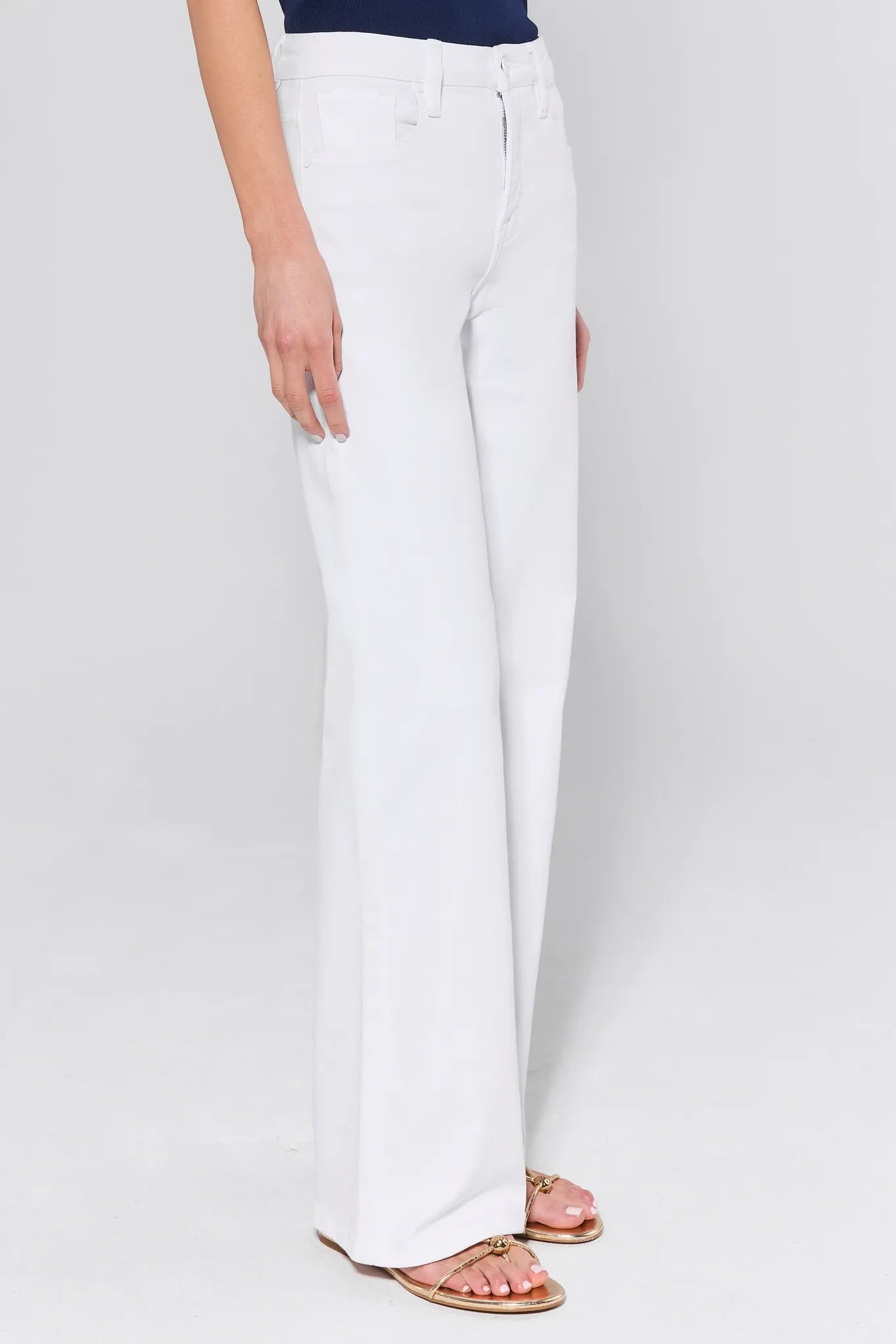 White pants worn by a person on a white background