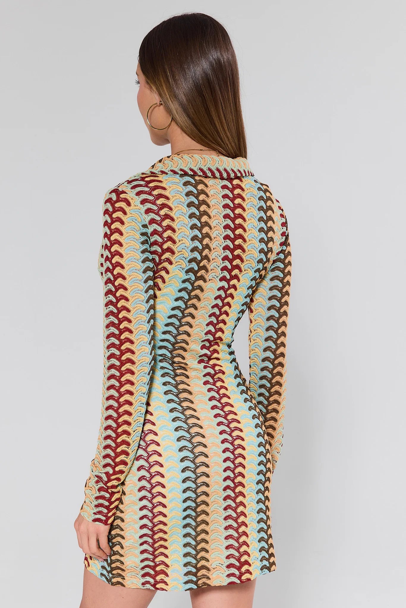 women wearing multicolor knit dress on plain background