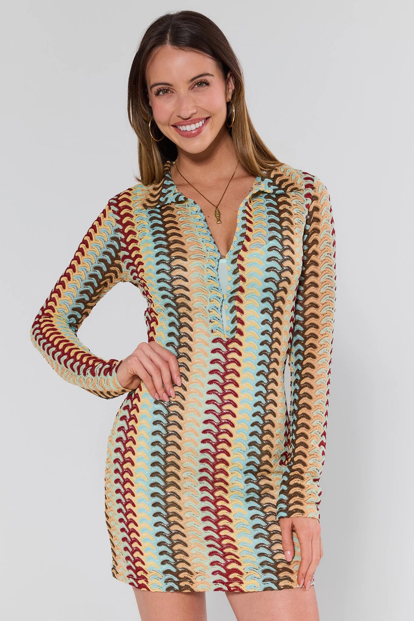 women wearing multicolor knit dress and gold fish necklace on grey background