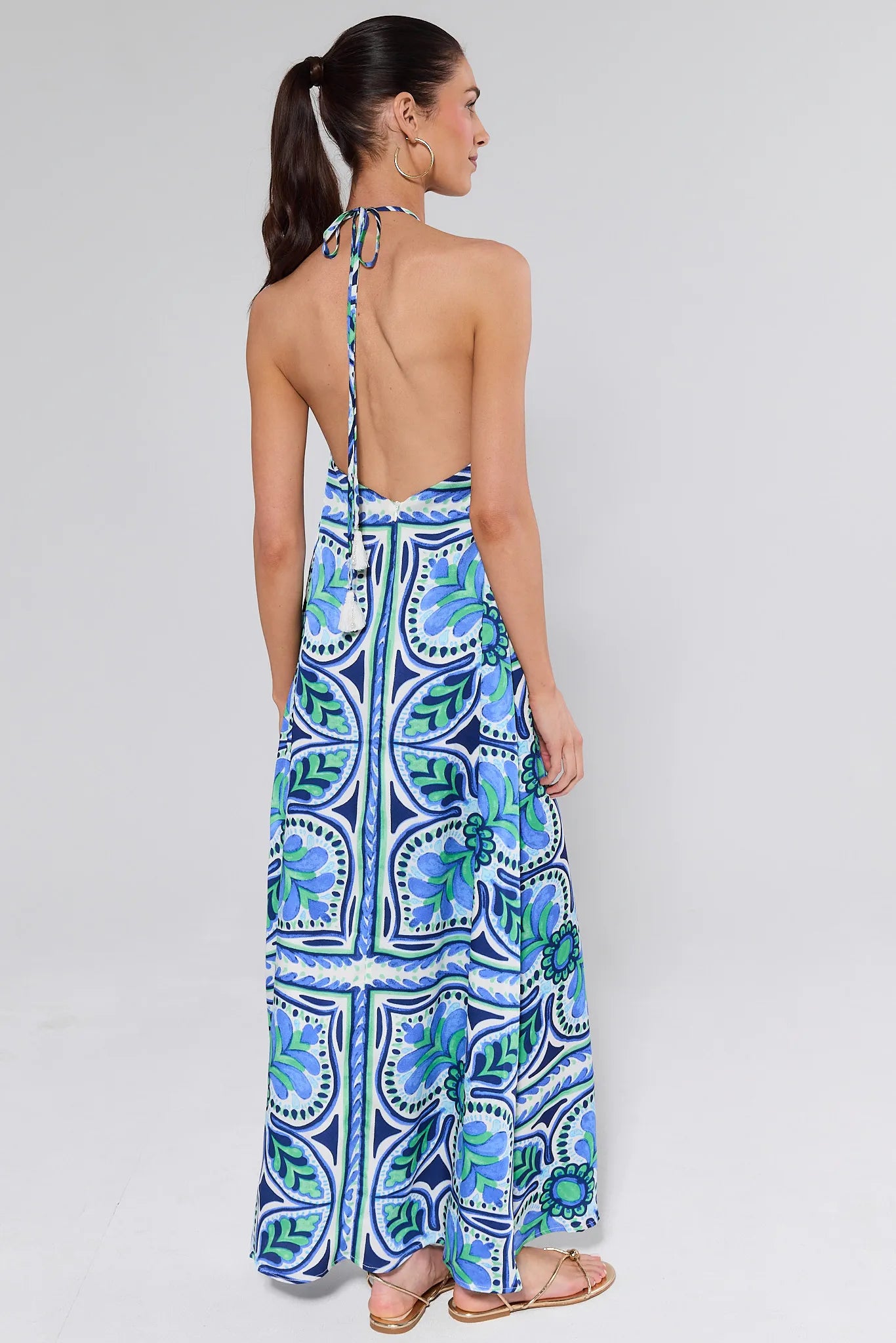 Woman wearing a blue patterned dress on a white background